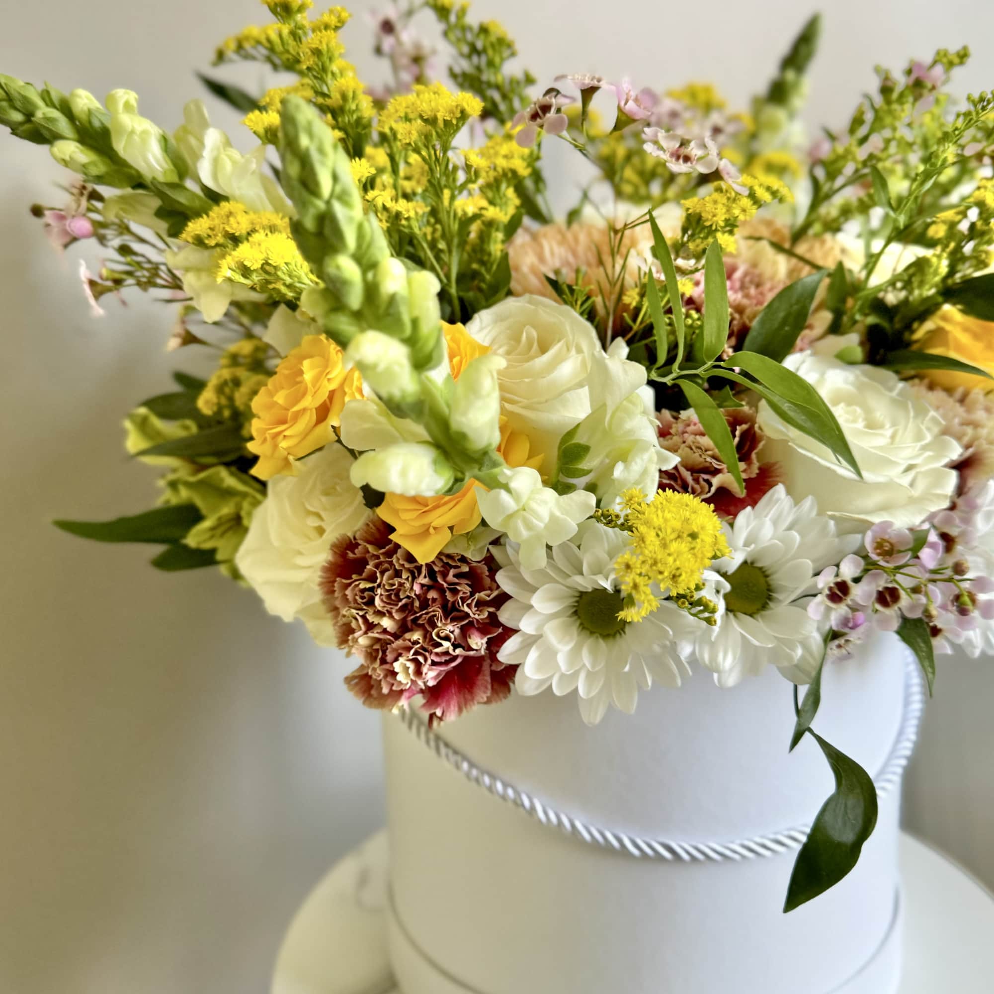 Mixed bouquet in a white hatbox with white, yellow, and pink flowers, photo 7 of 12