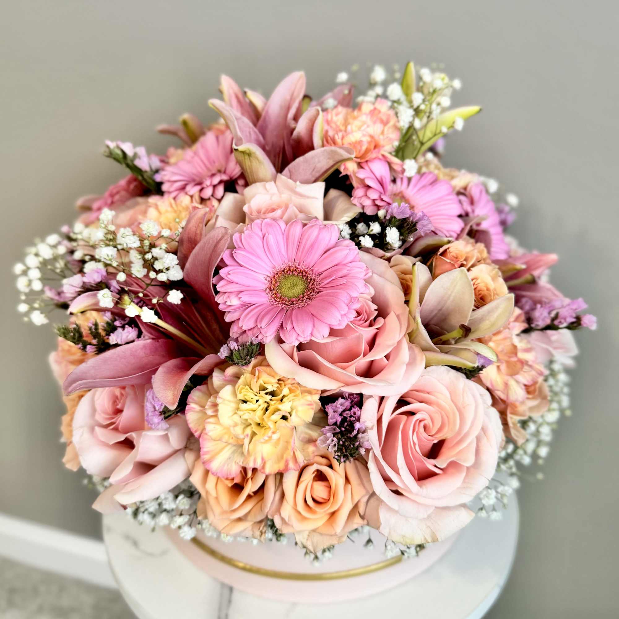Pink and peach bouquet with roses, gerbera daisies, and lilies