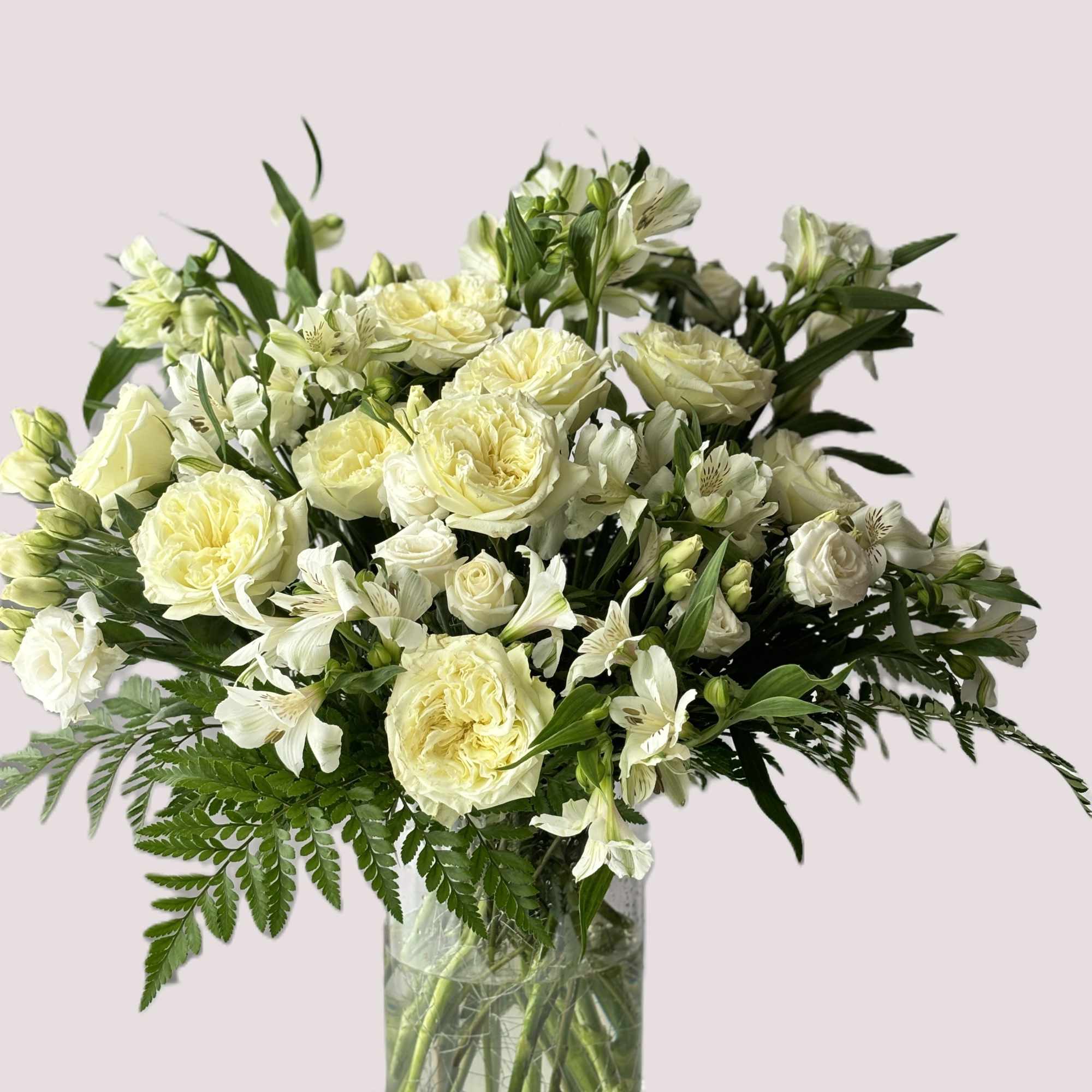 White roses and alstroemeria in a clear glass vase