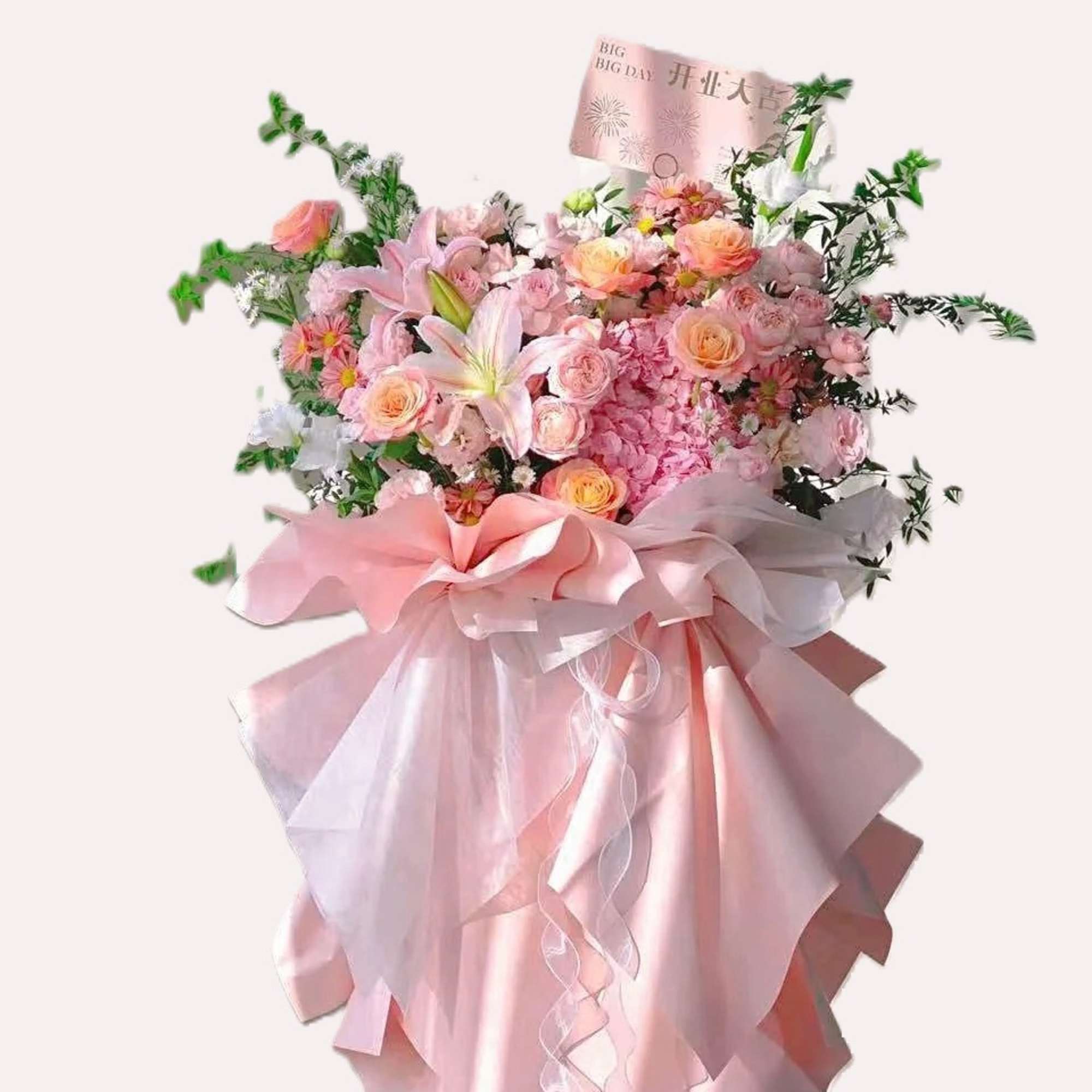 Large pink bouquet with lilies, roses, and a satin ribbon wrap