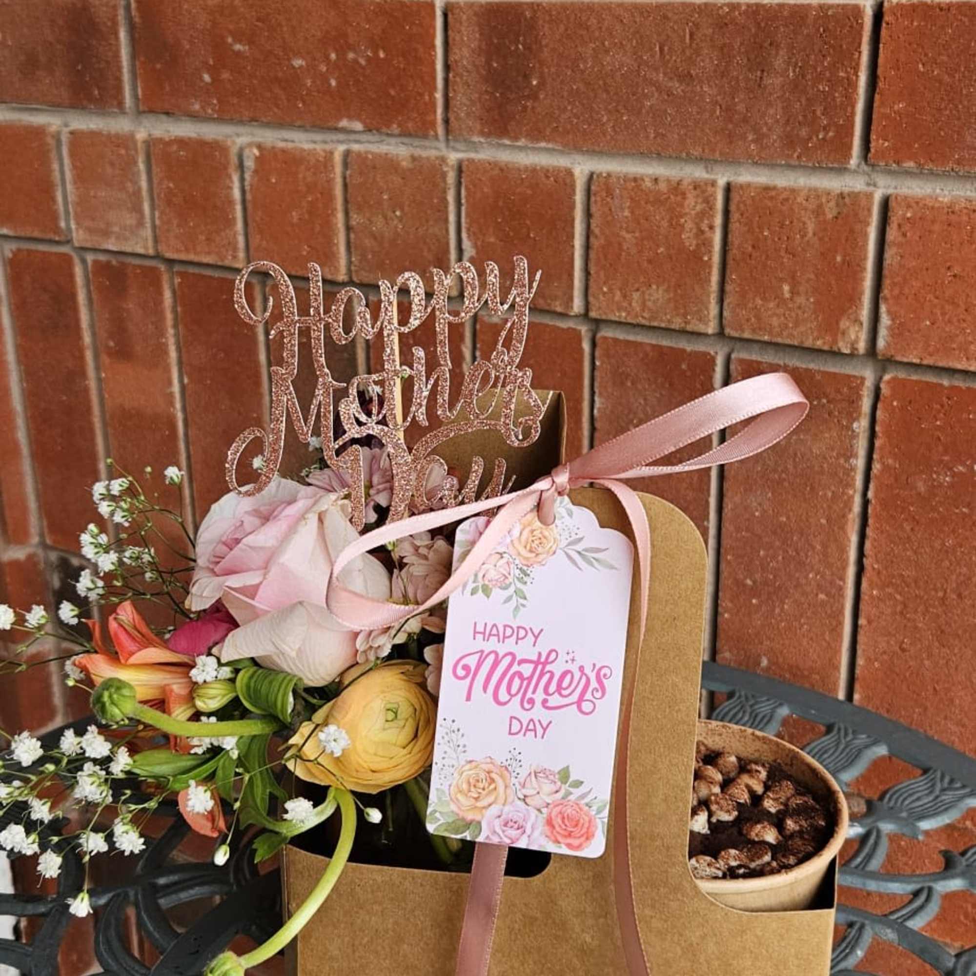 Mother's Day flower gift bag with pastel blooms and a ribbon tag