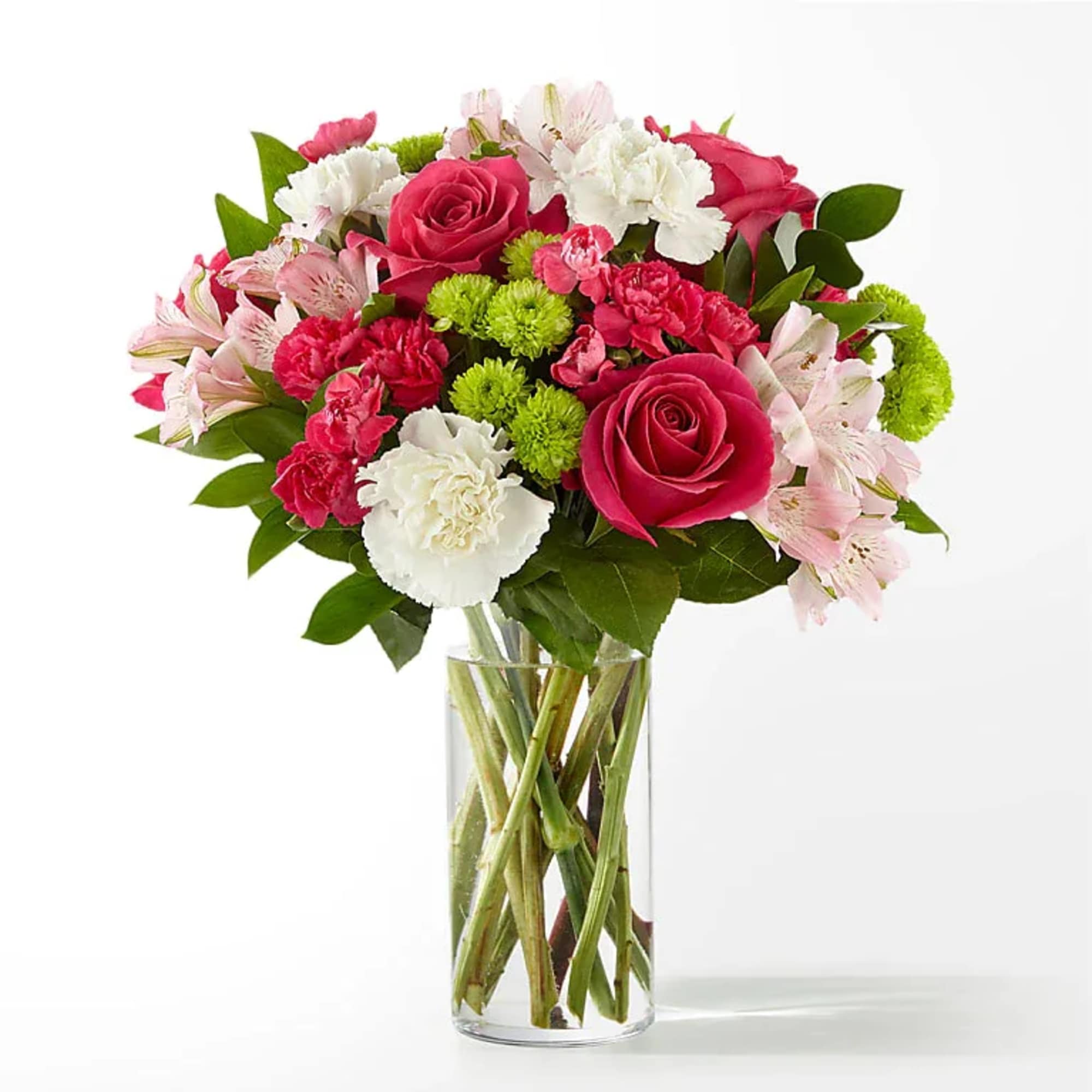 Bouquet of pink roses, carnations, and white flowers in a glass vase