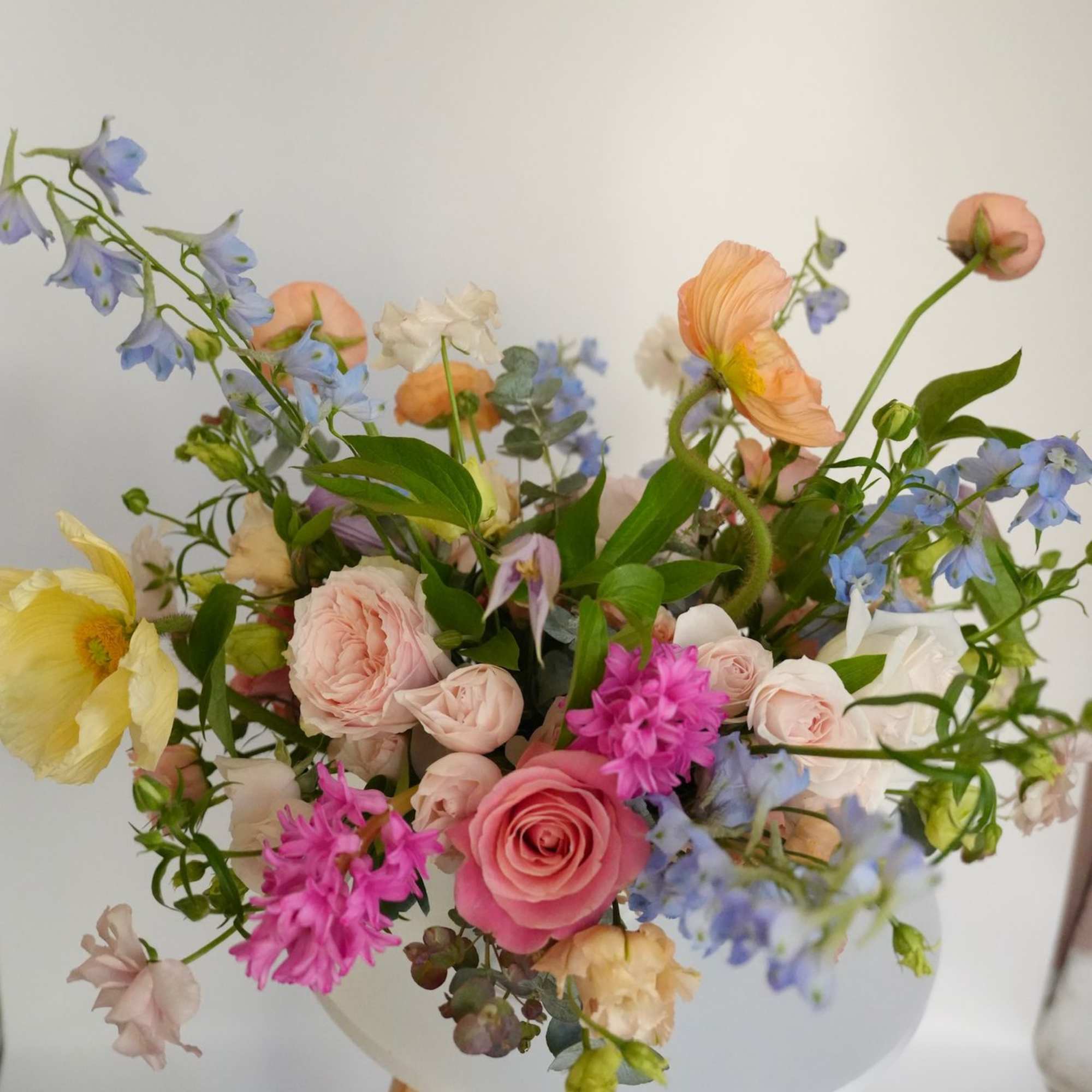 Mixed pastel bouquet in a white vase