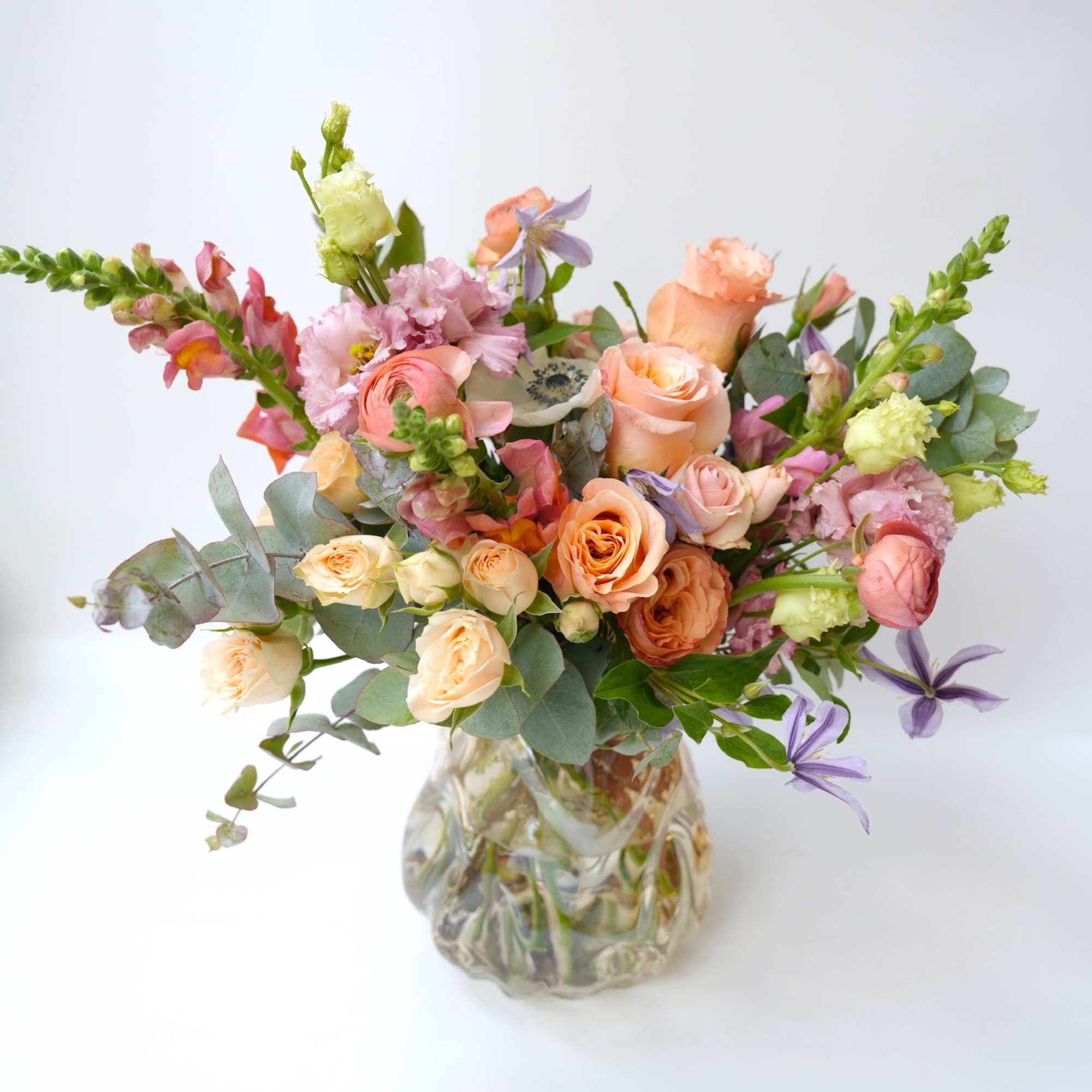 Mixed pastel bouquet in a clear glass vase