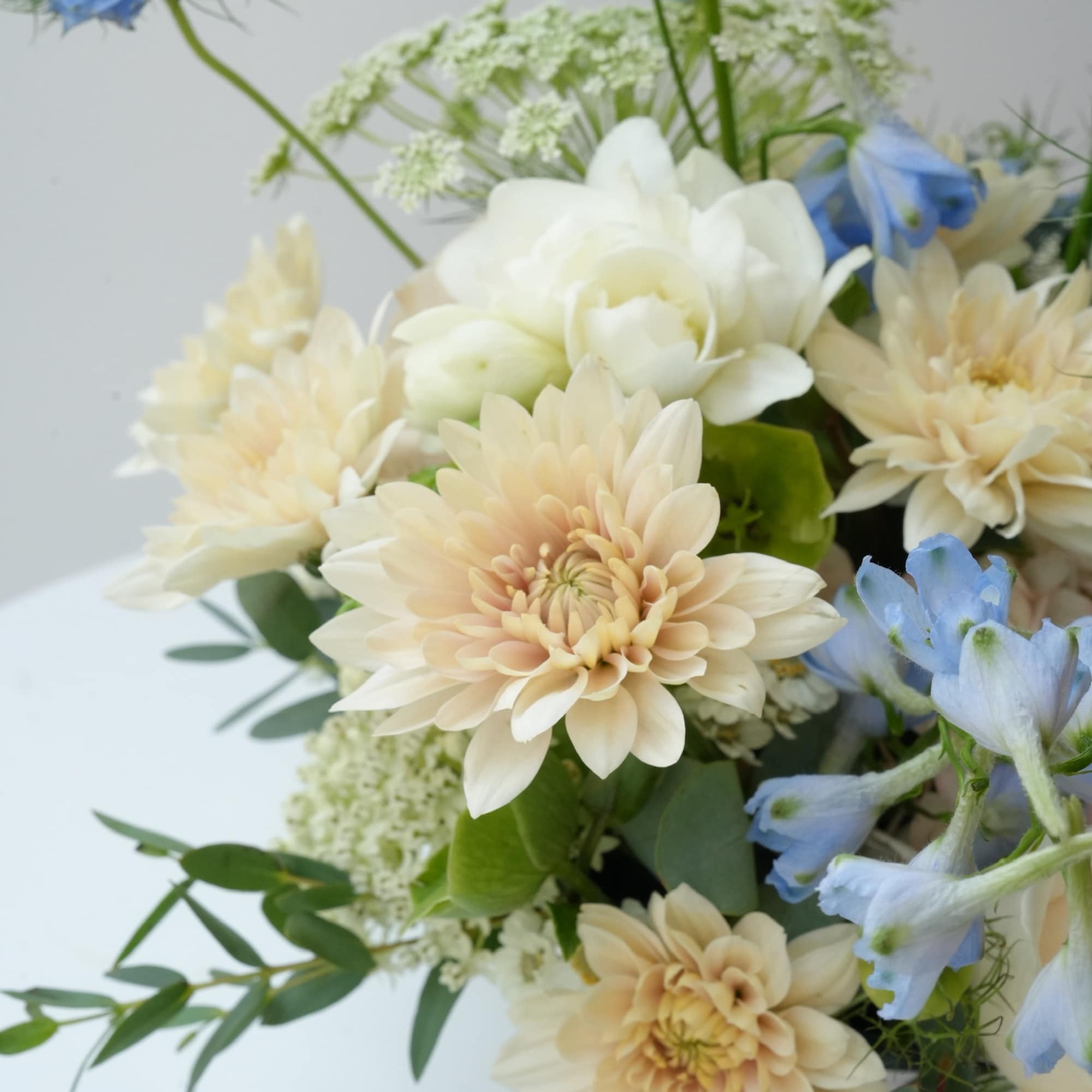 Bouquet of cream dahlias and pale blue flowers
