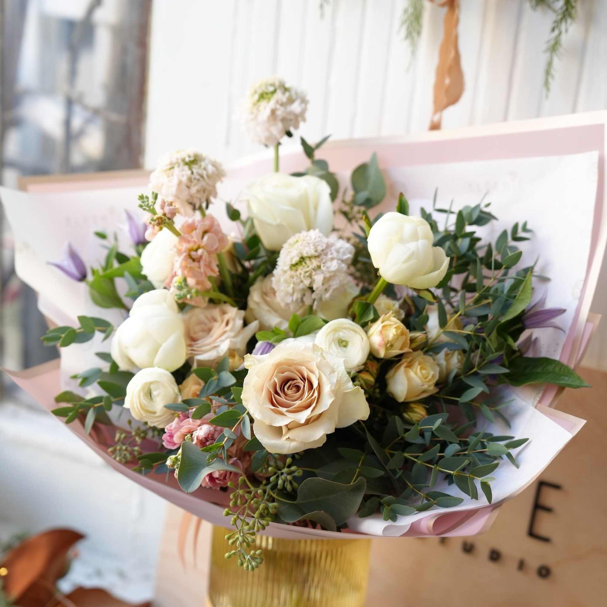 Bouquet of cream roses and white tulips with pink accents