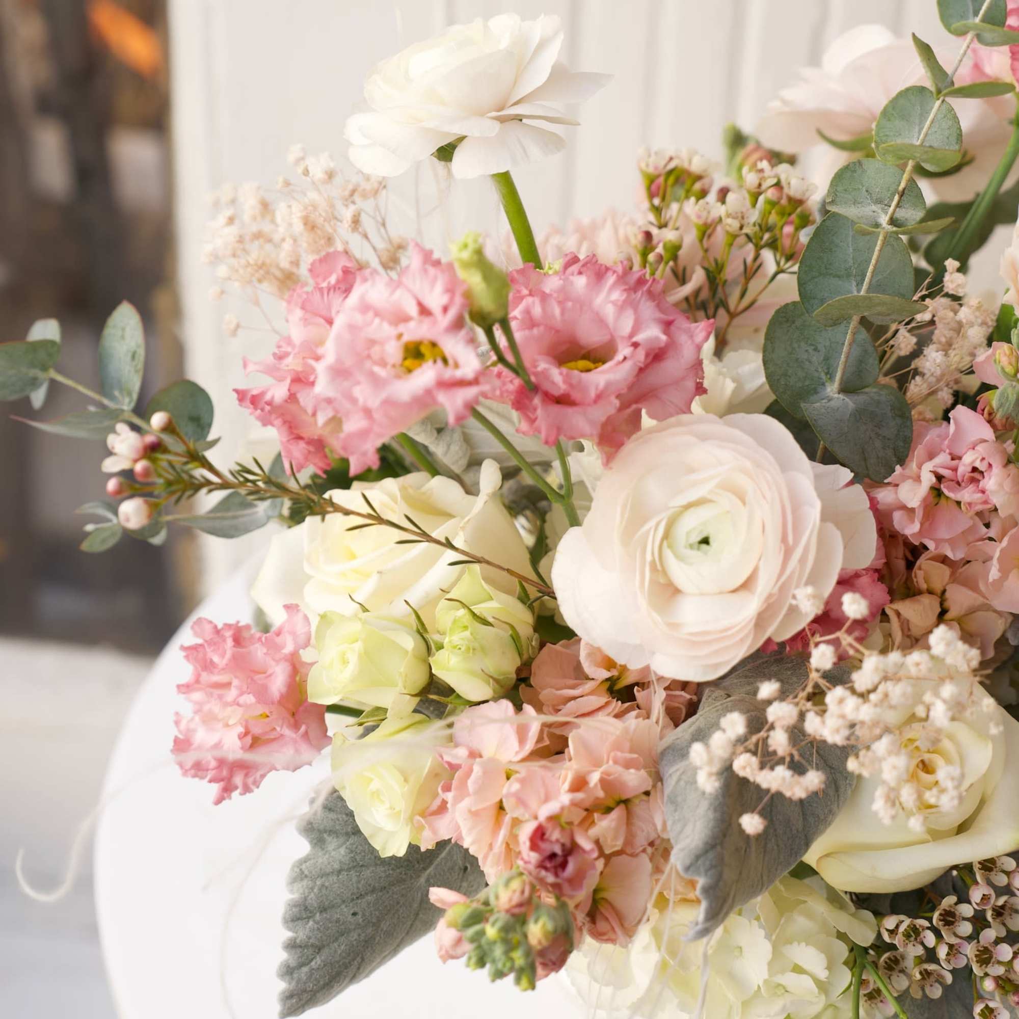 Bouquet of pink and white flowers with eucalyptus and soft gray leaves