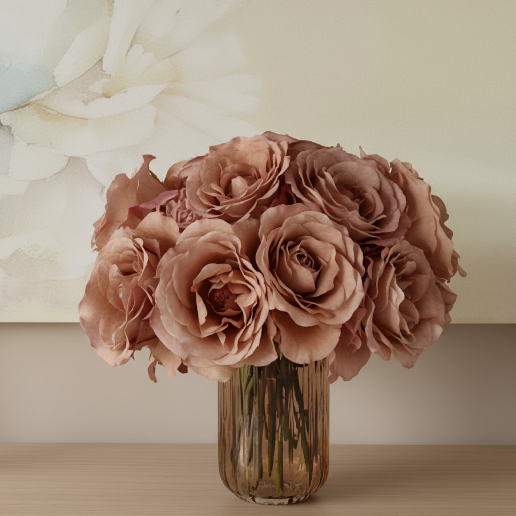 Blush roses arranged in a ribbed glass vase on a tabletop