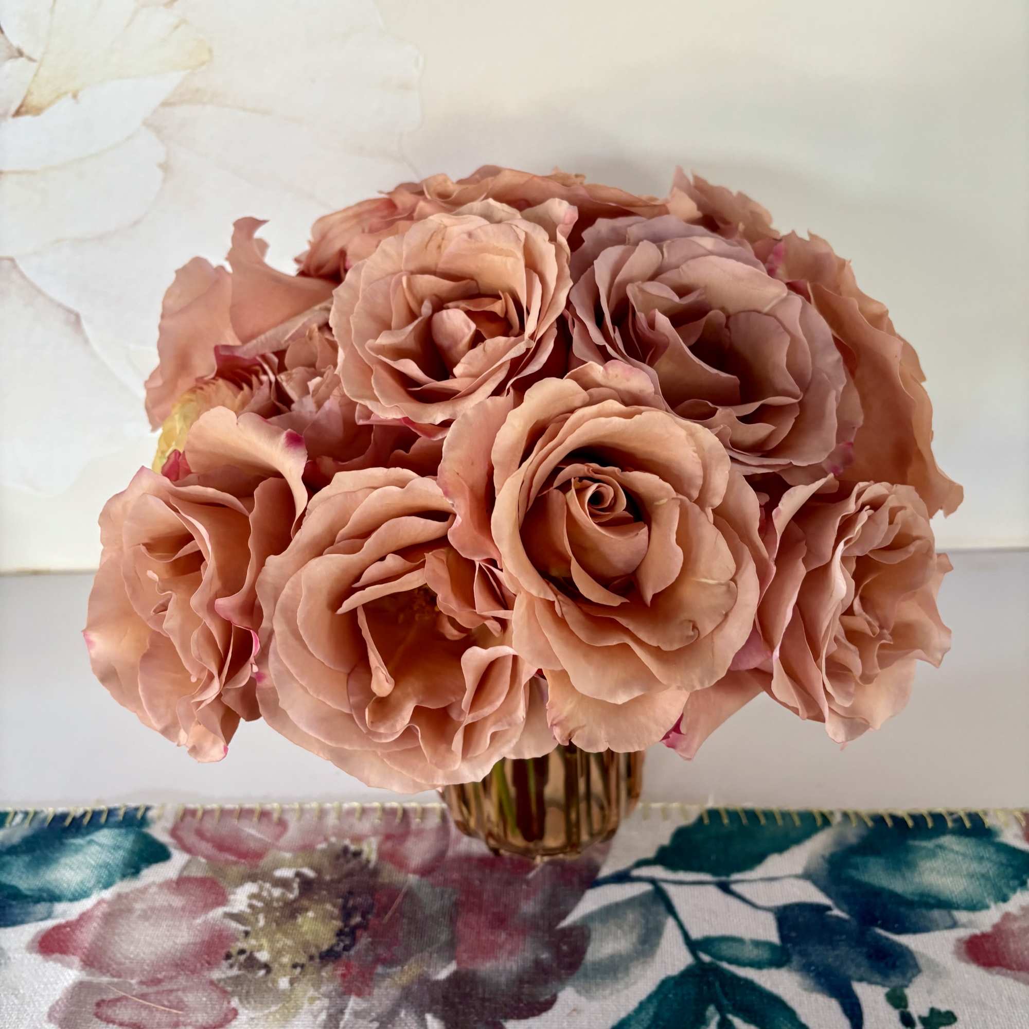 Peach rose bouquet in a small glass vase