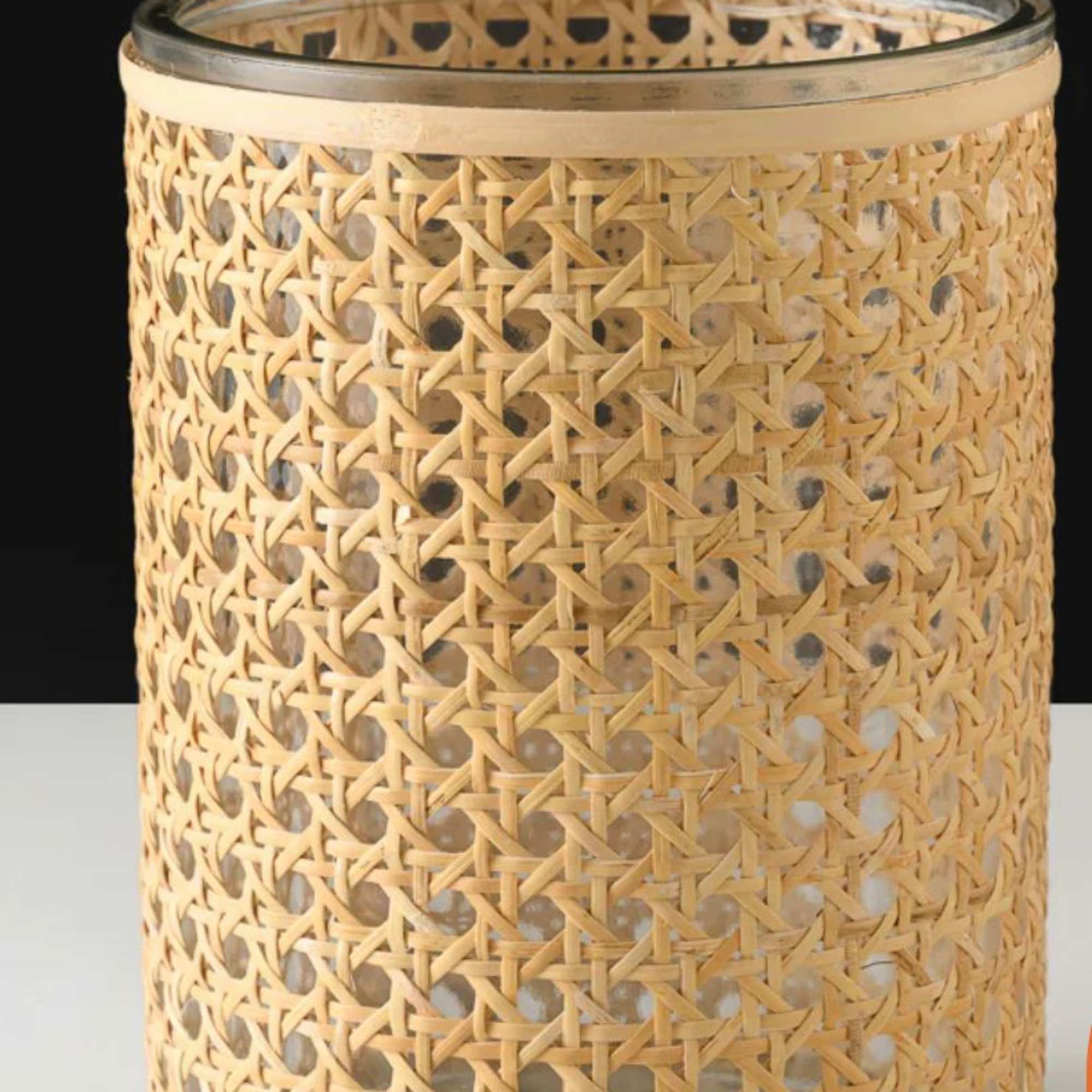 Woven bamboo candle holder with a glass insert