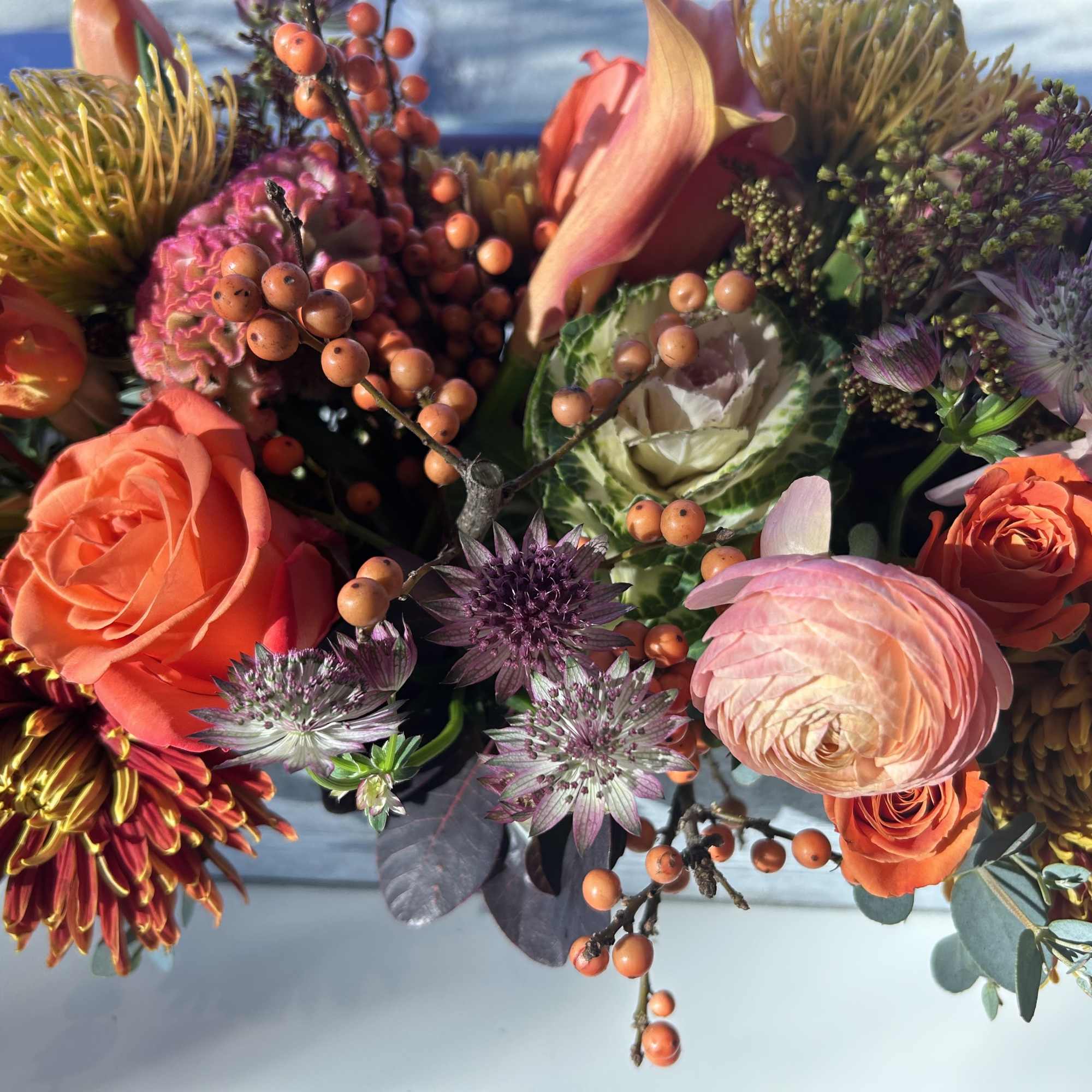 Colorful mixed bouquet with roses, chrysanthemums, and berries