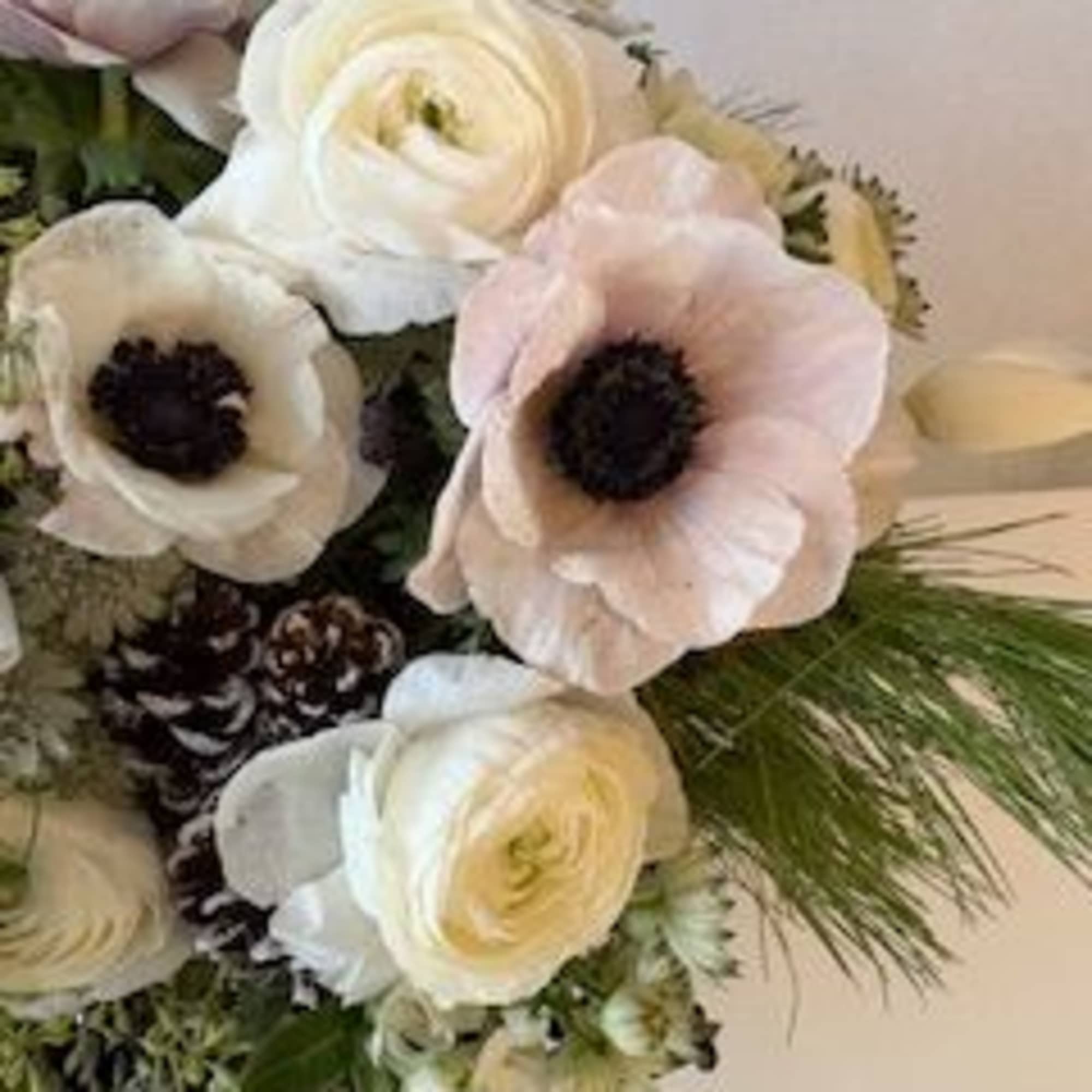 Bouquet of white and pale pink flowers with dark centers