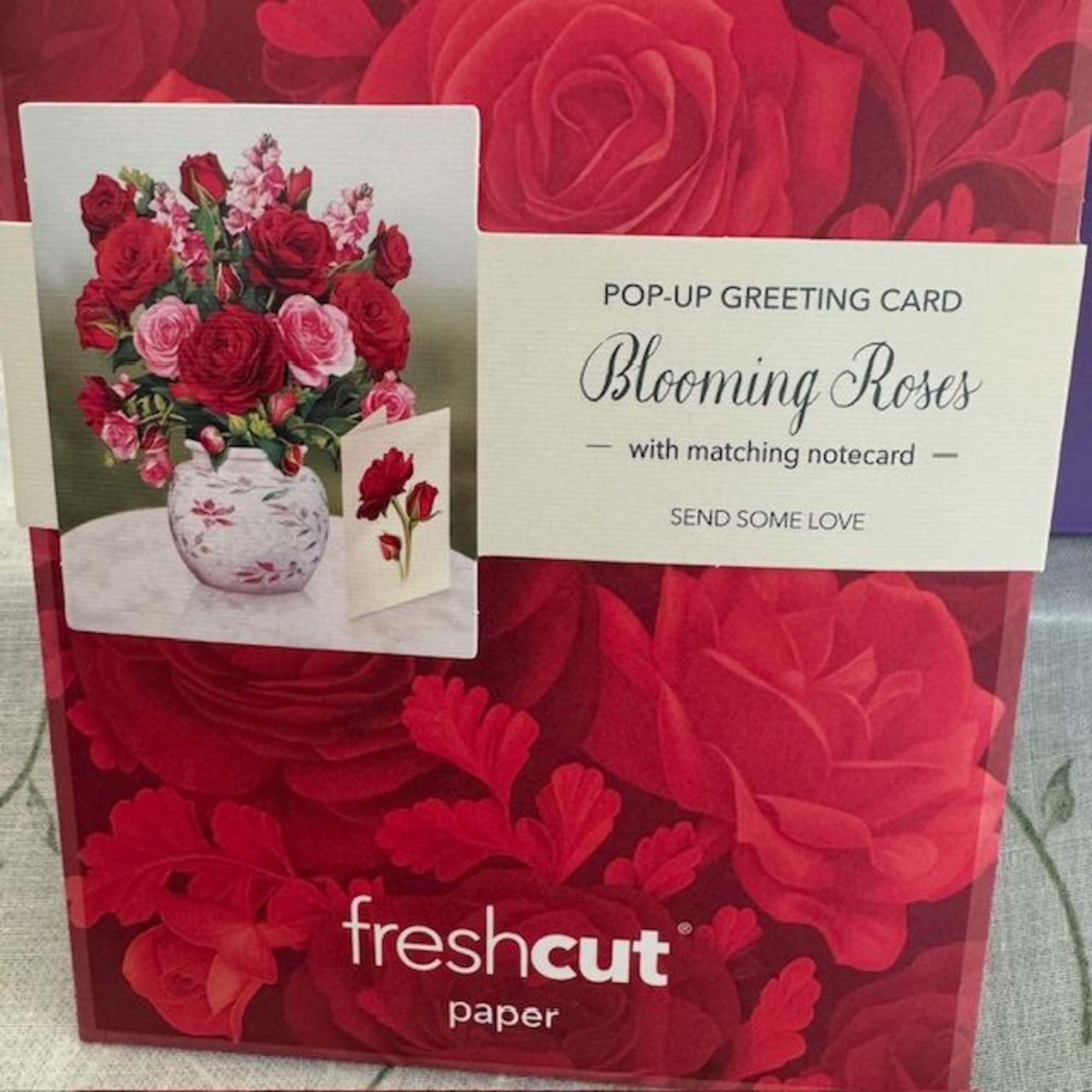 Pop-up greeting card with red and pink roses in a vase