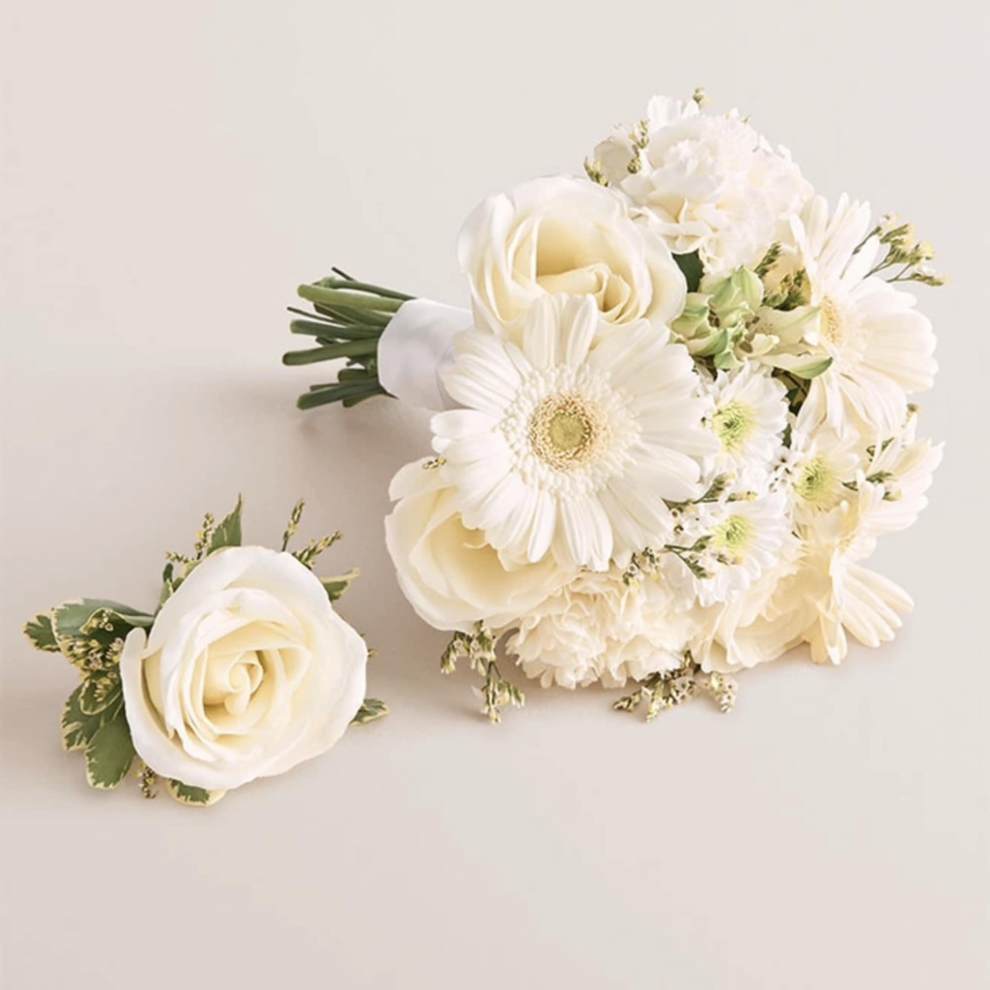 White rose and daisy bouquet with a matching boutonniere