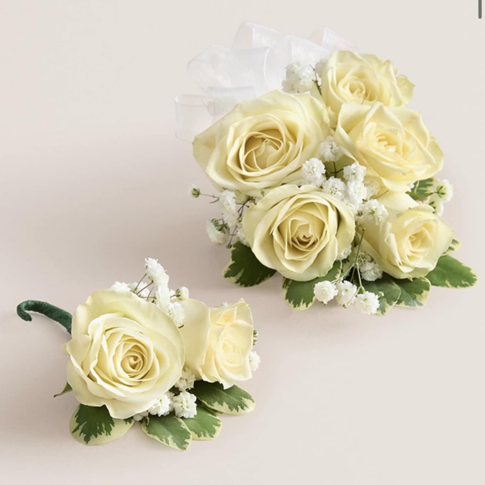This elegant corsage and boutonniere set is thoughtfully designed to pair perfectly