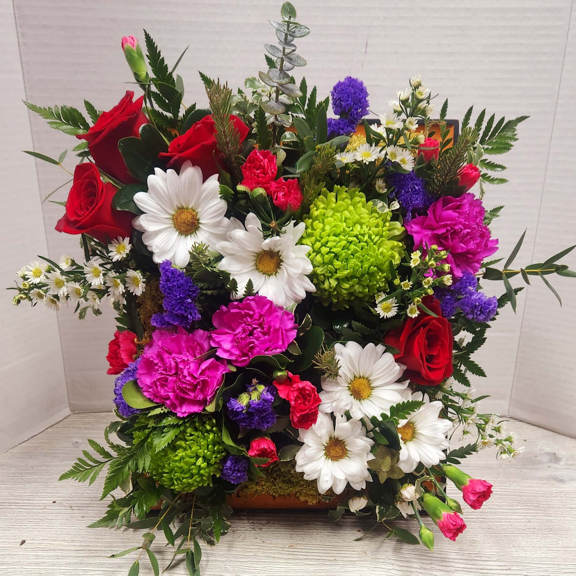 Colorful mixed bouquet with roses, daisies, carnations, and hydrangeas