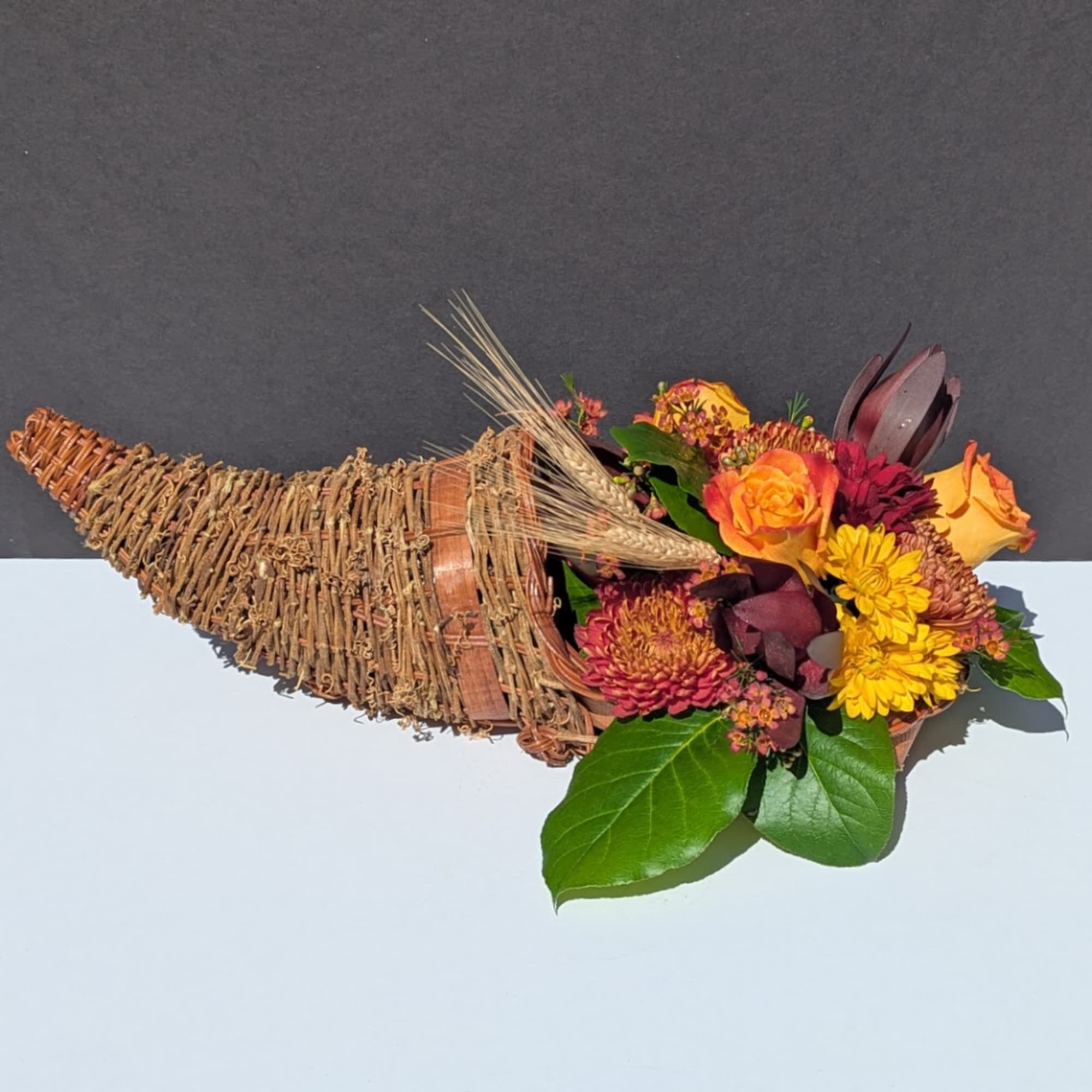 Cornucopia basket with orange and yellow flowers