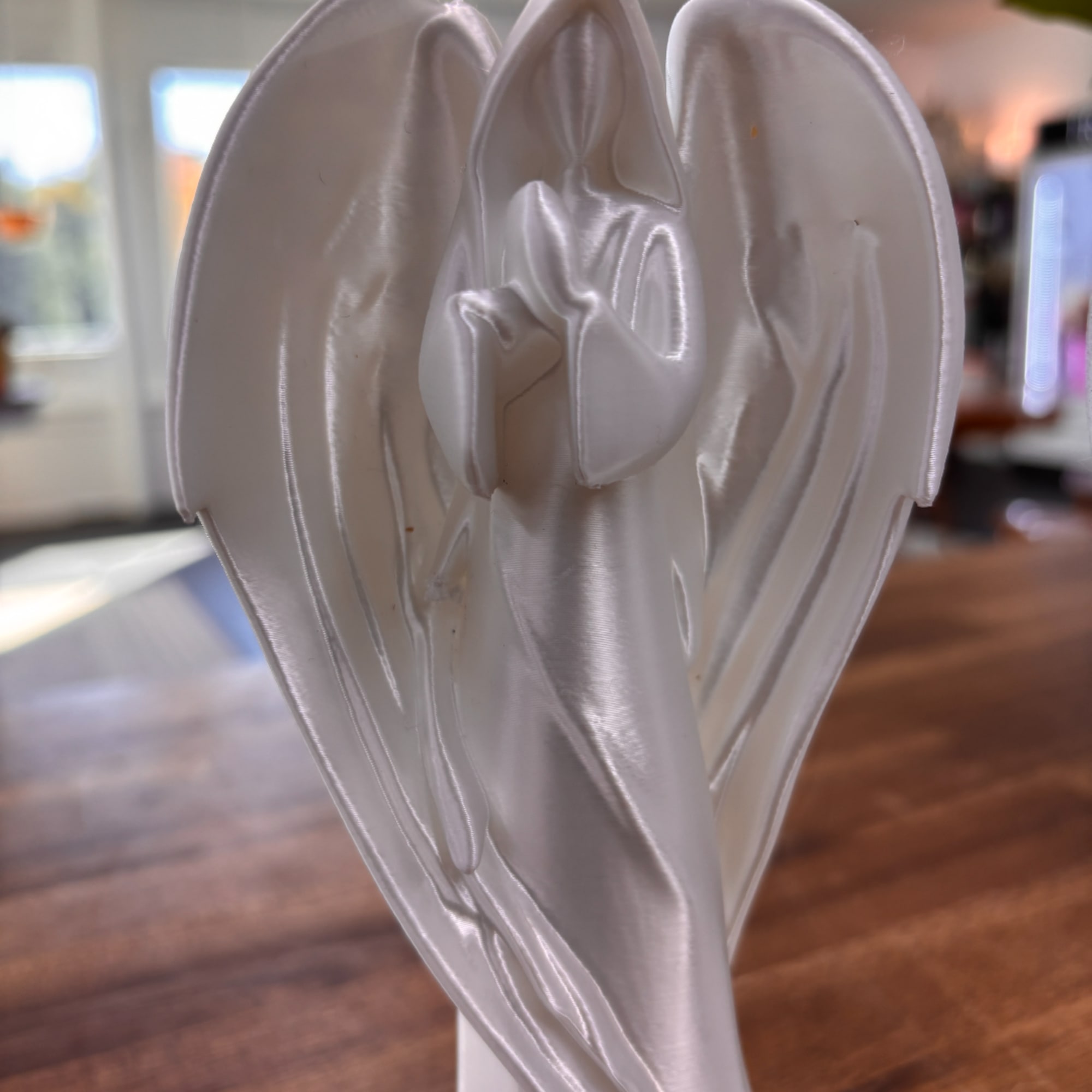 White satin angel ornament on a table