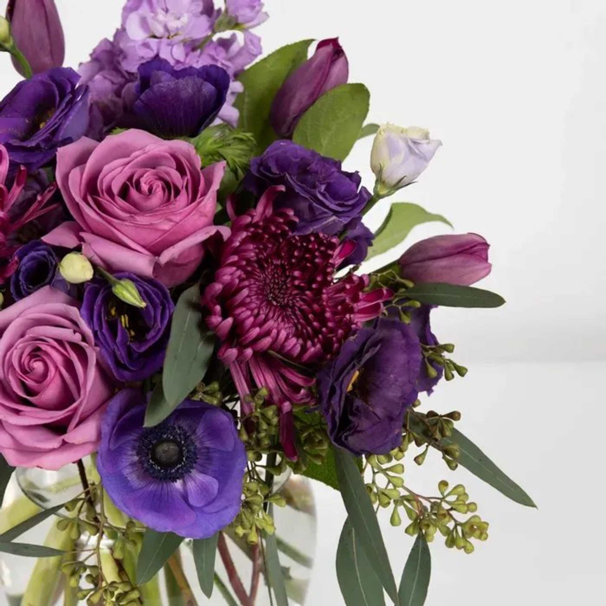 Purple and pink bouquet with roses and mixed blooms