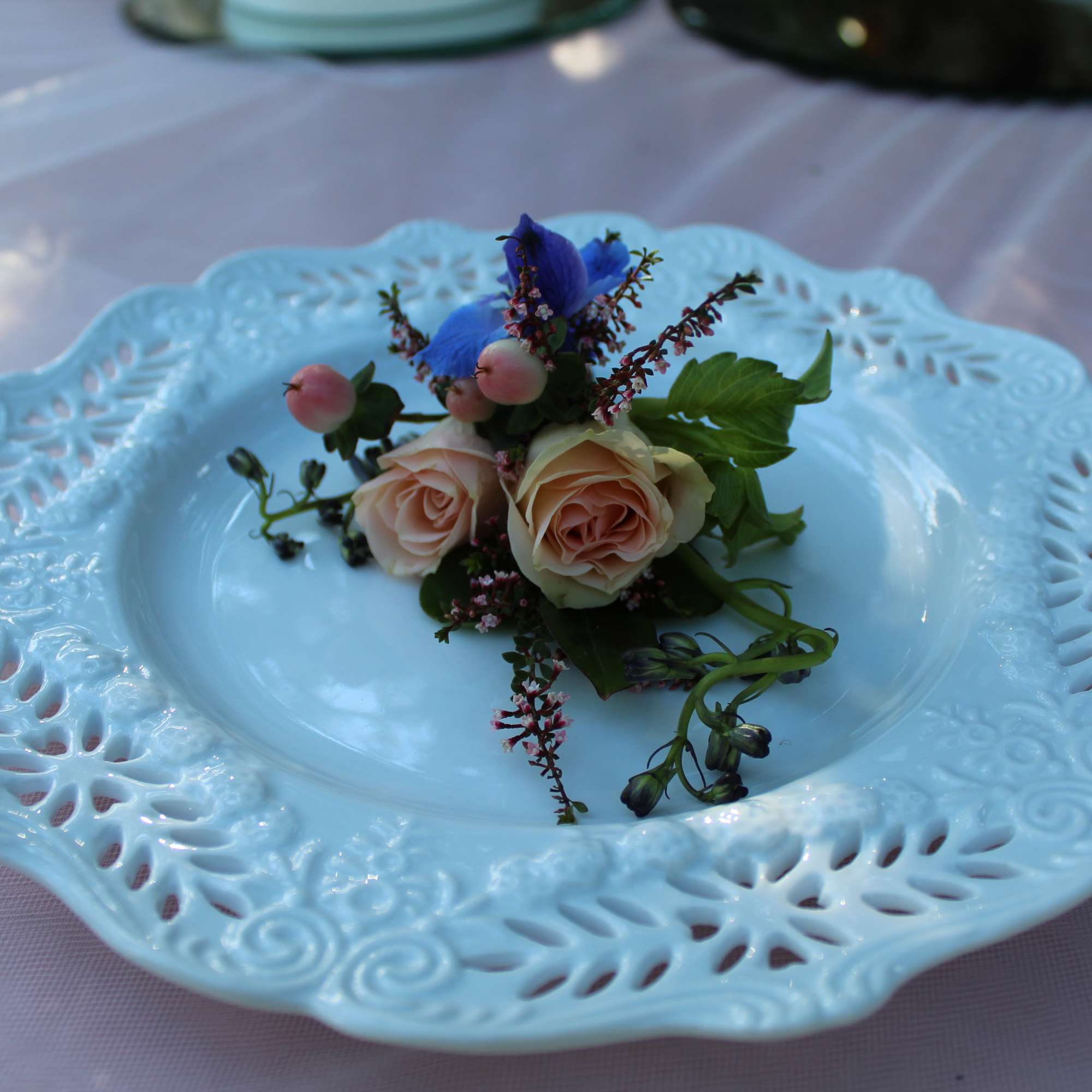 Small floral arrangement on a decorative white plate