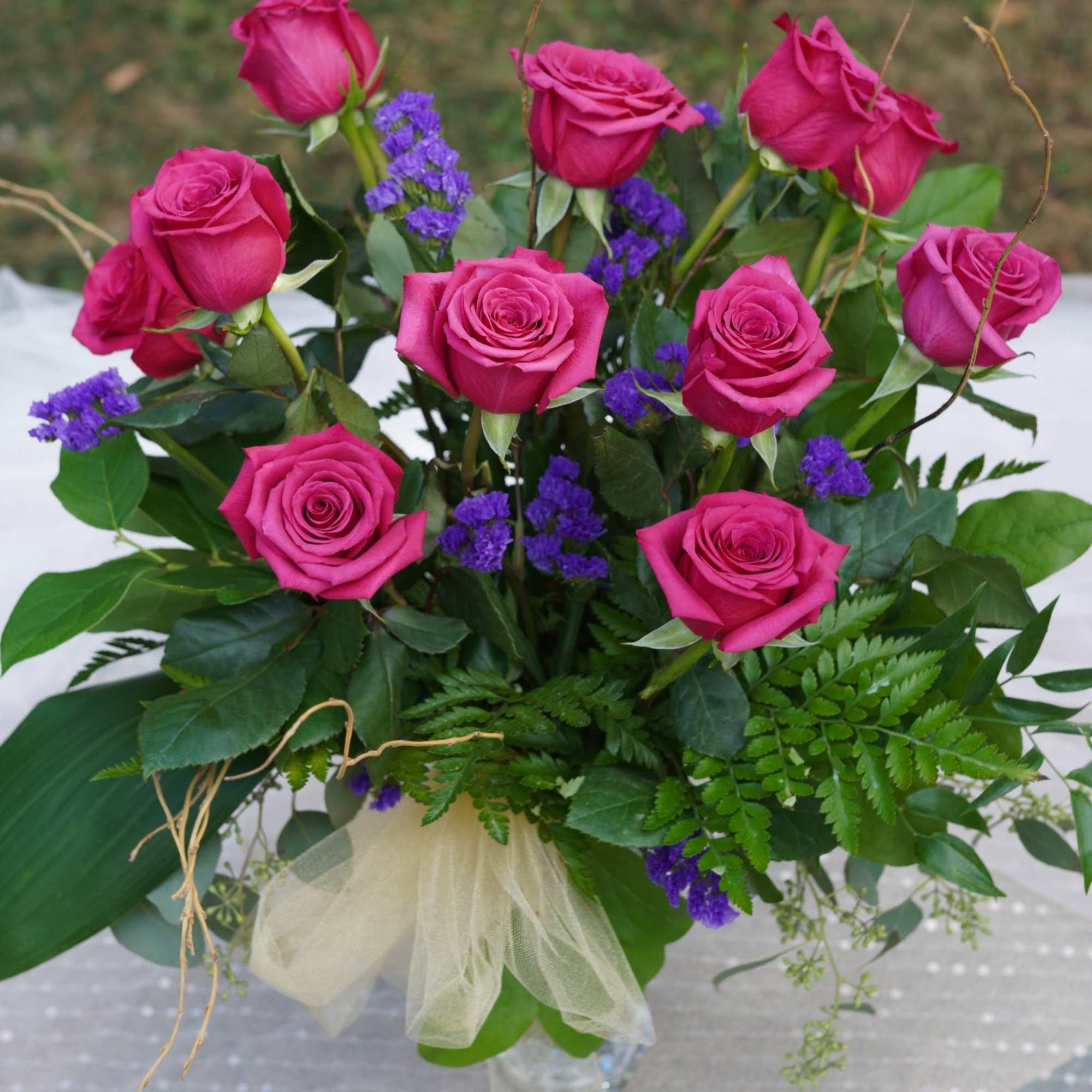 Bouquet of hot pink roses with purple filler flowers