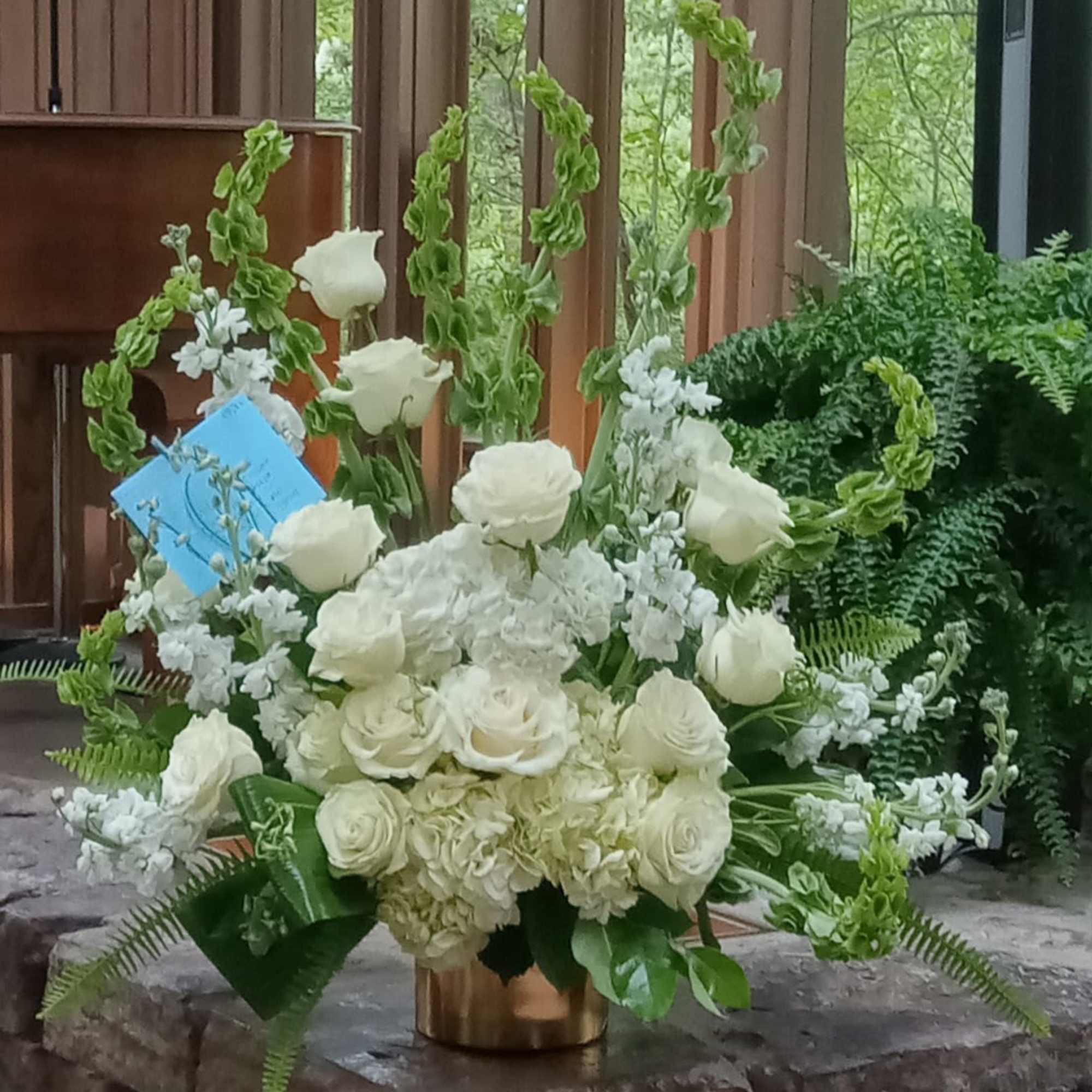 An all white tribute, this funeral basket is pure and tranquil. Featuring