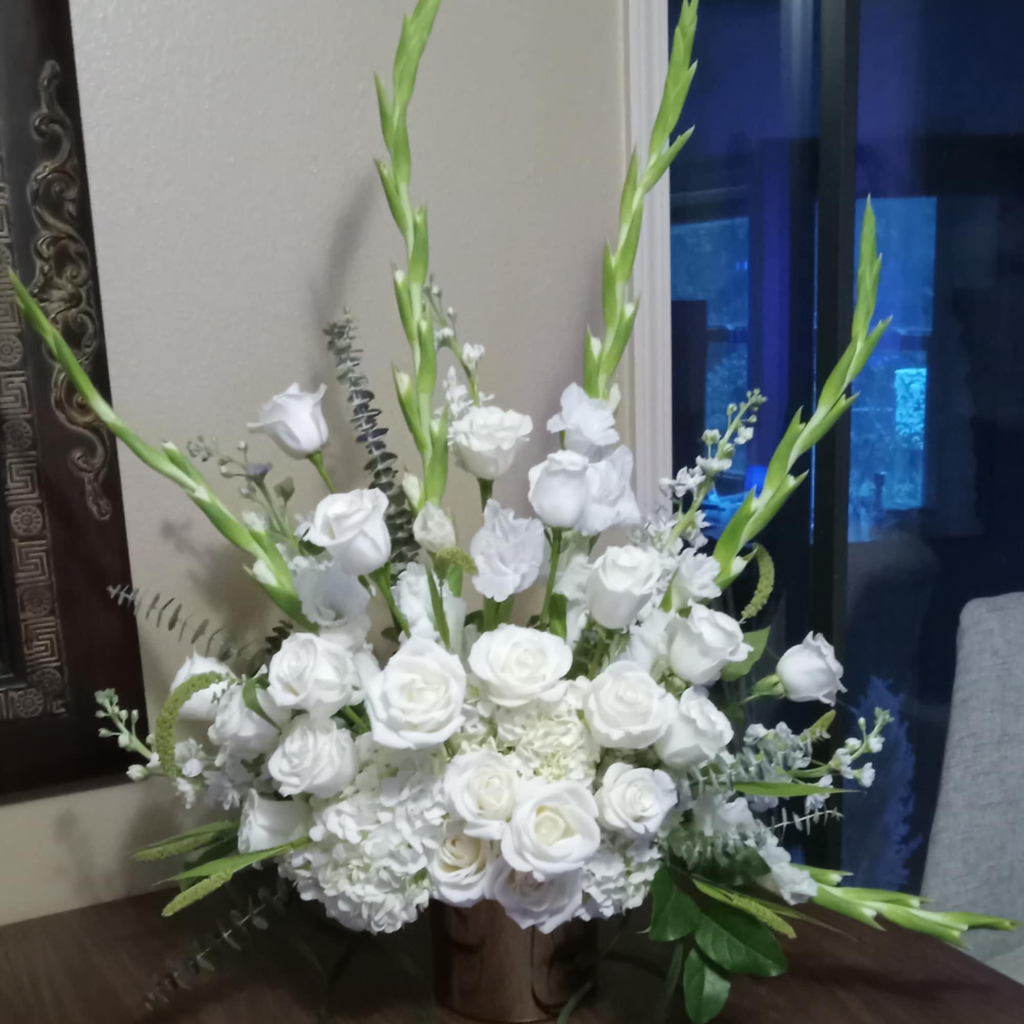 An all white tribute, this funeral basket is pure and tranquil. Featuring