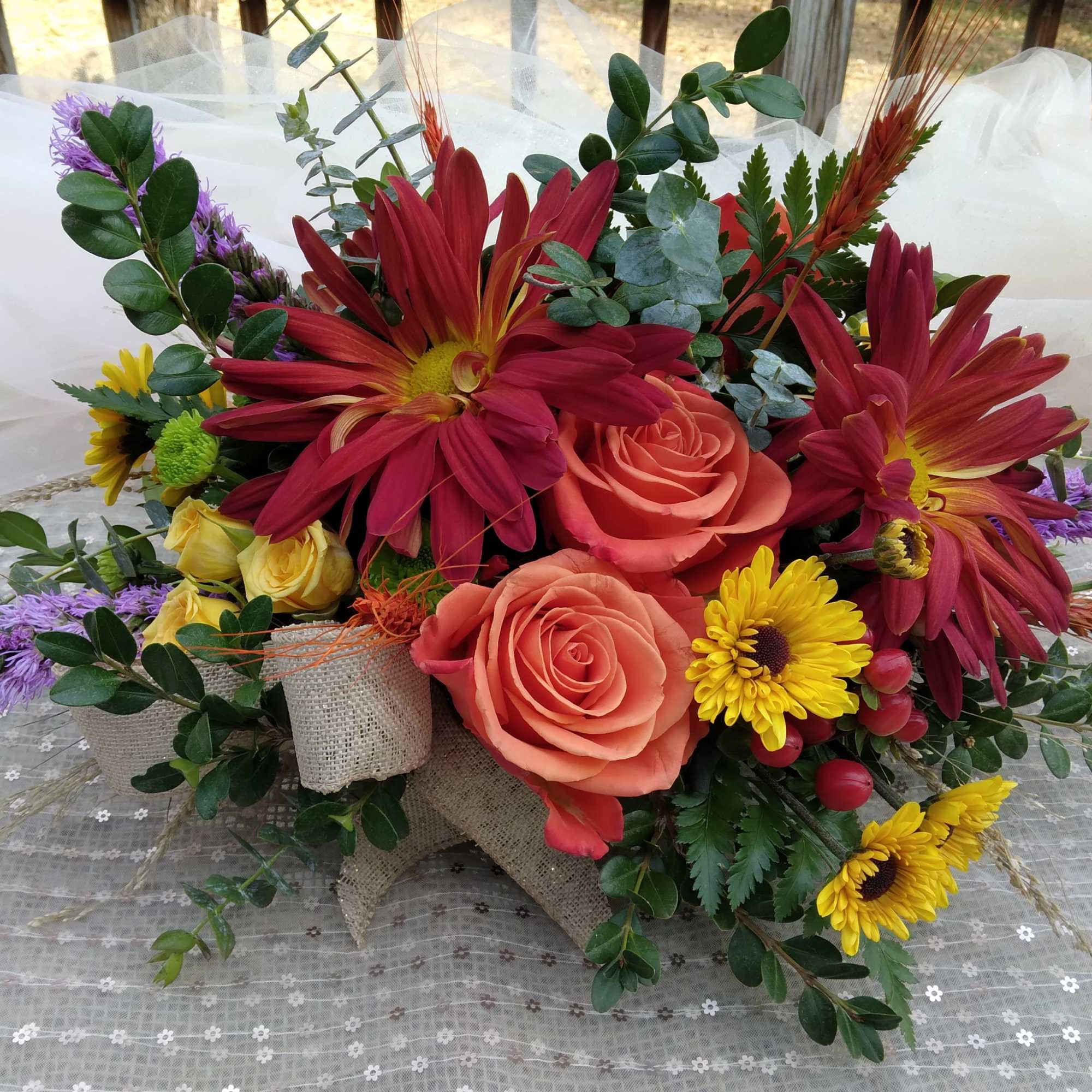 A perfect autumn centerpiece for your dinner party, this arrangement features roses