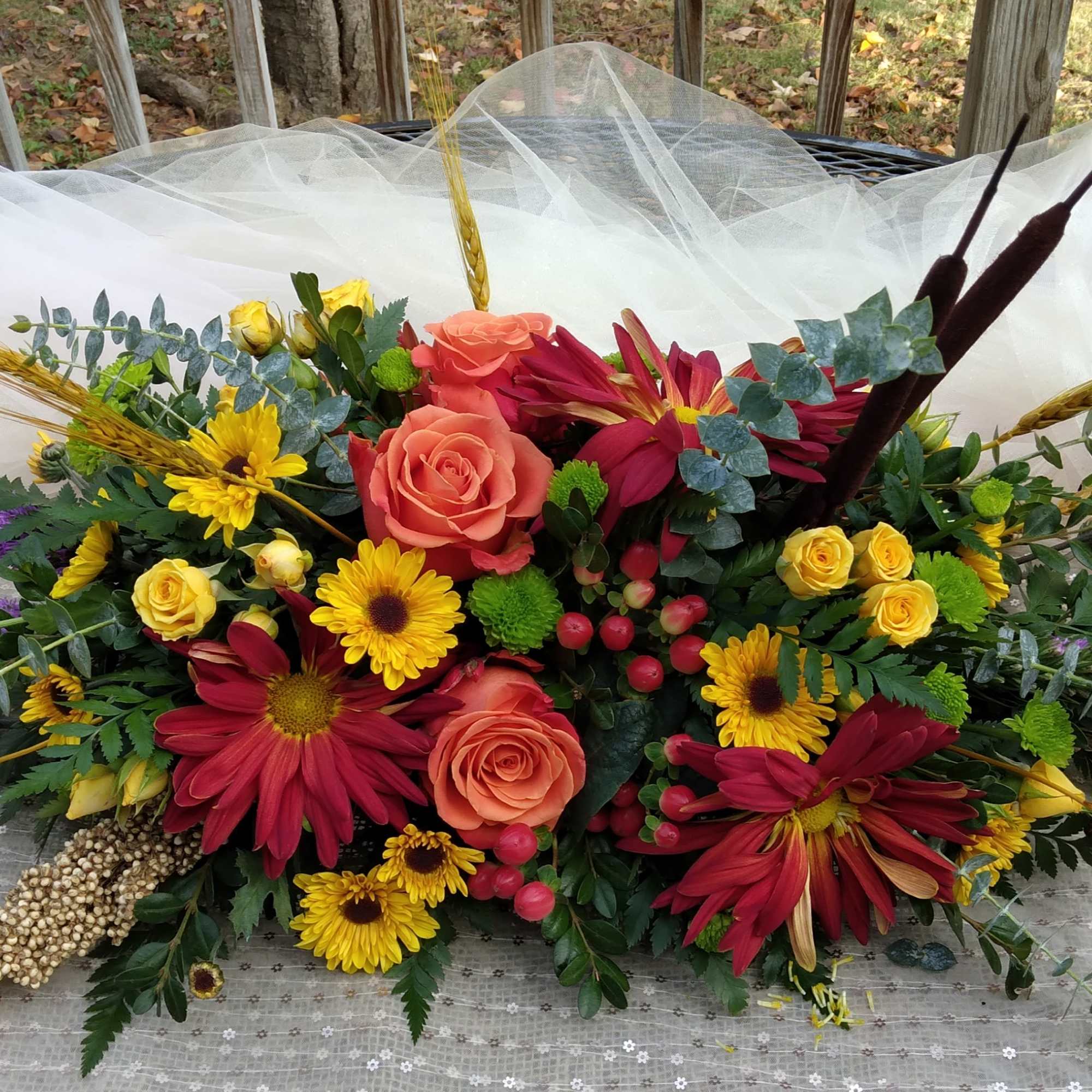 A perfect autumn centerpiece for your dinner party, this arrangement features roses