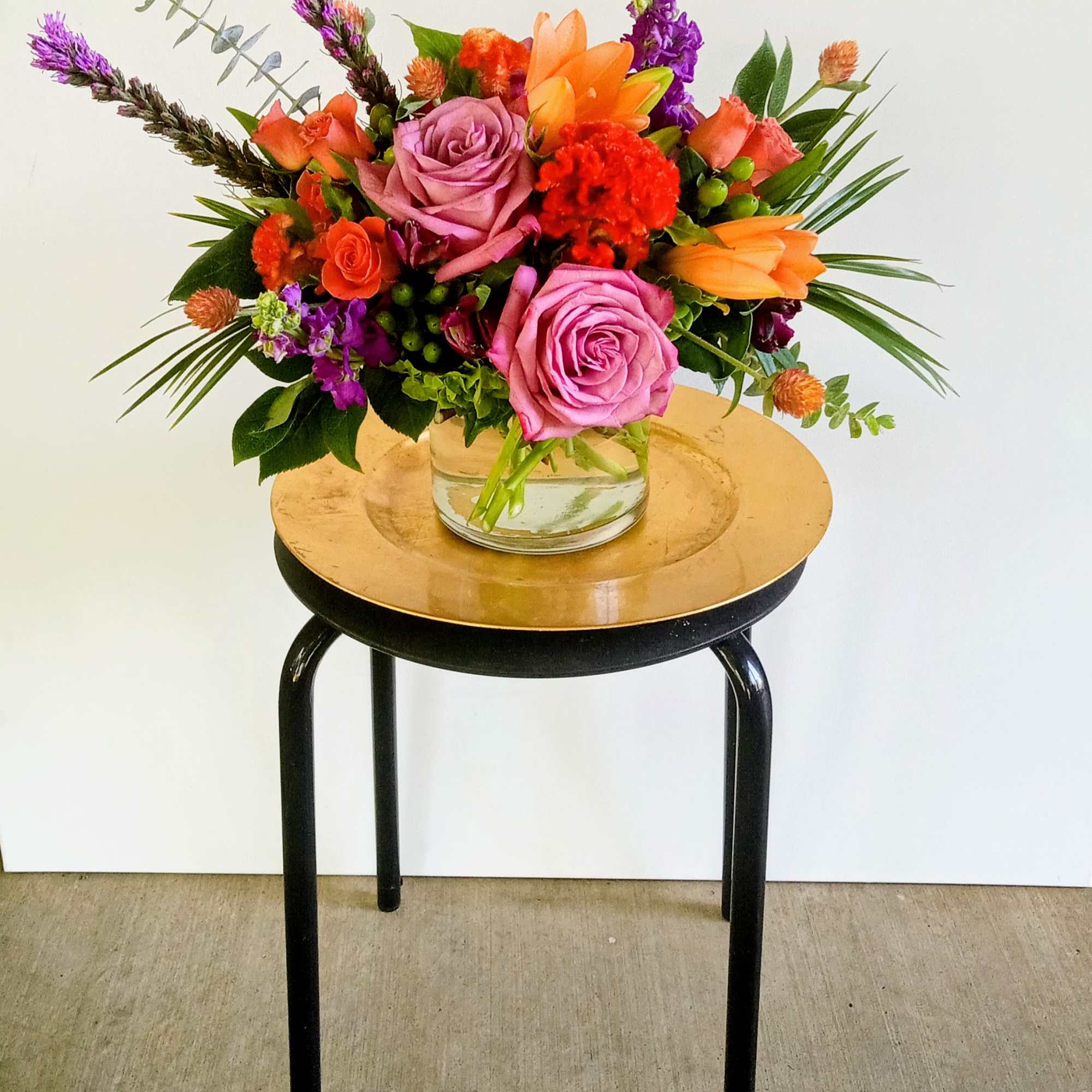 Colorful mixed flower arrangement in a clear glass vase