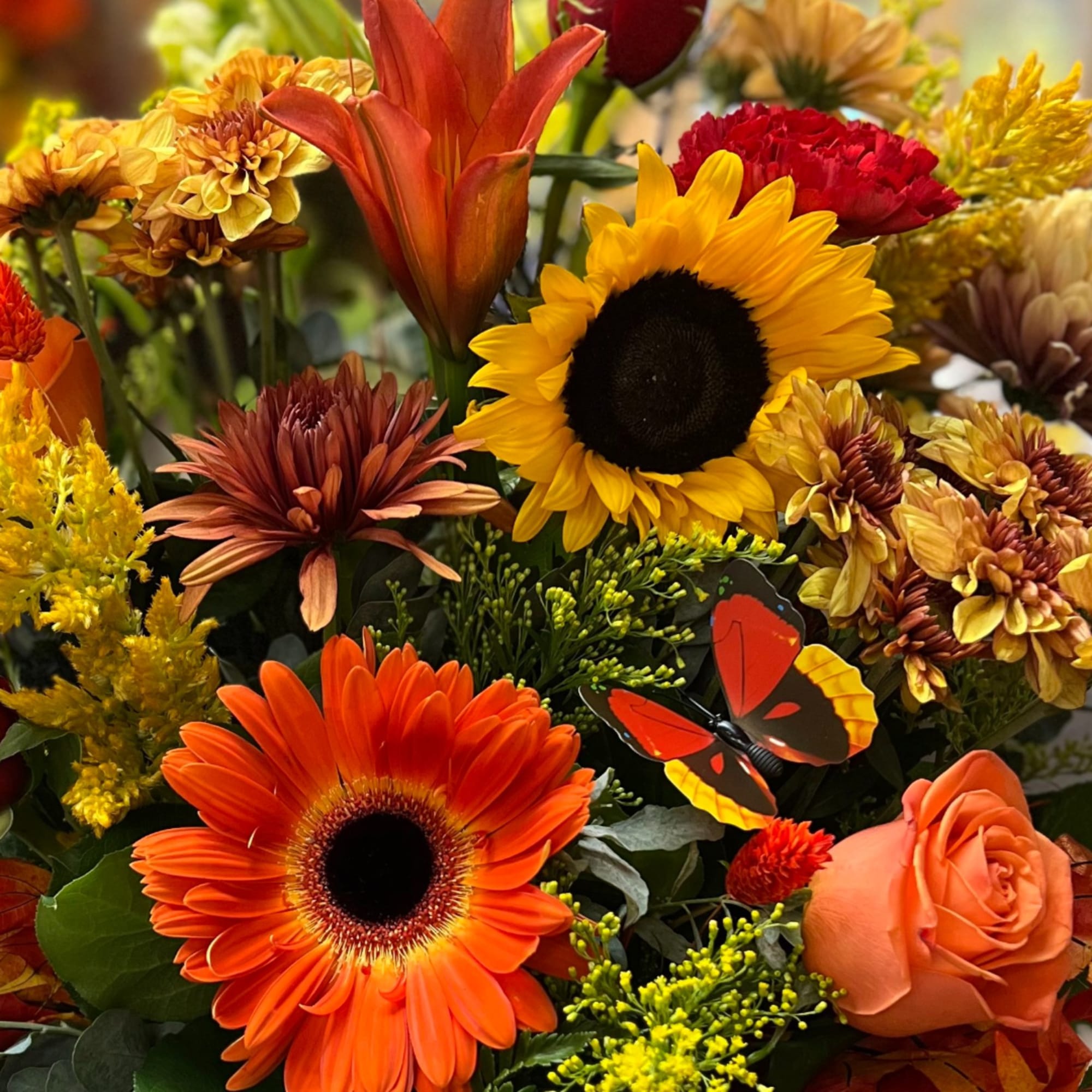 Autumn bouquet with orange gerbera daisies, sunflowers, and roses