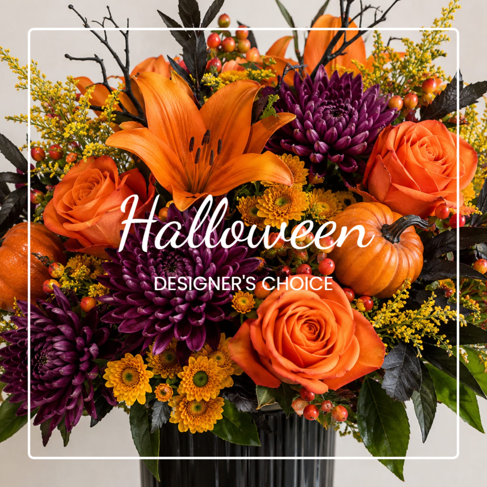 Halloween bouquet with orange roses, purple mums, and a pumpkin accent