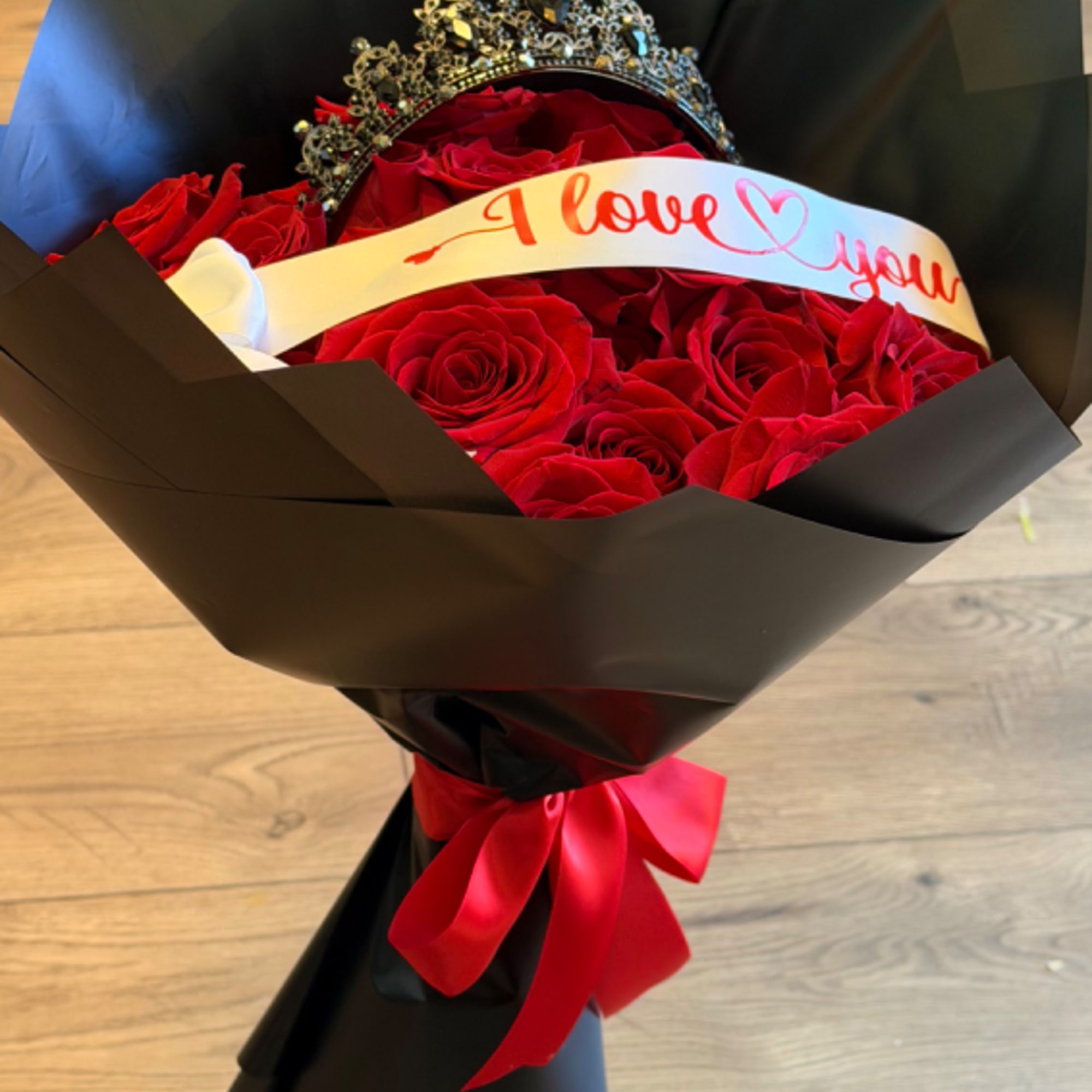 Red rose bouquet with a crown and "I love you" ribbon
