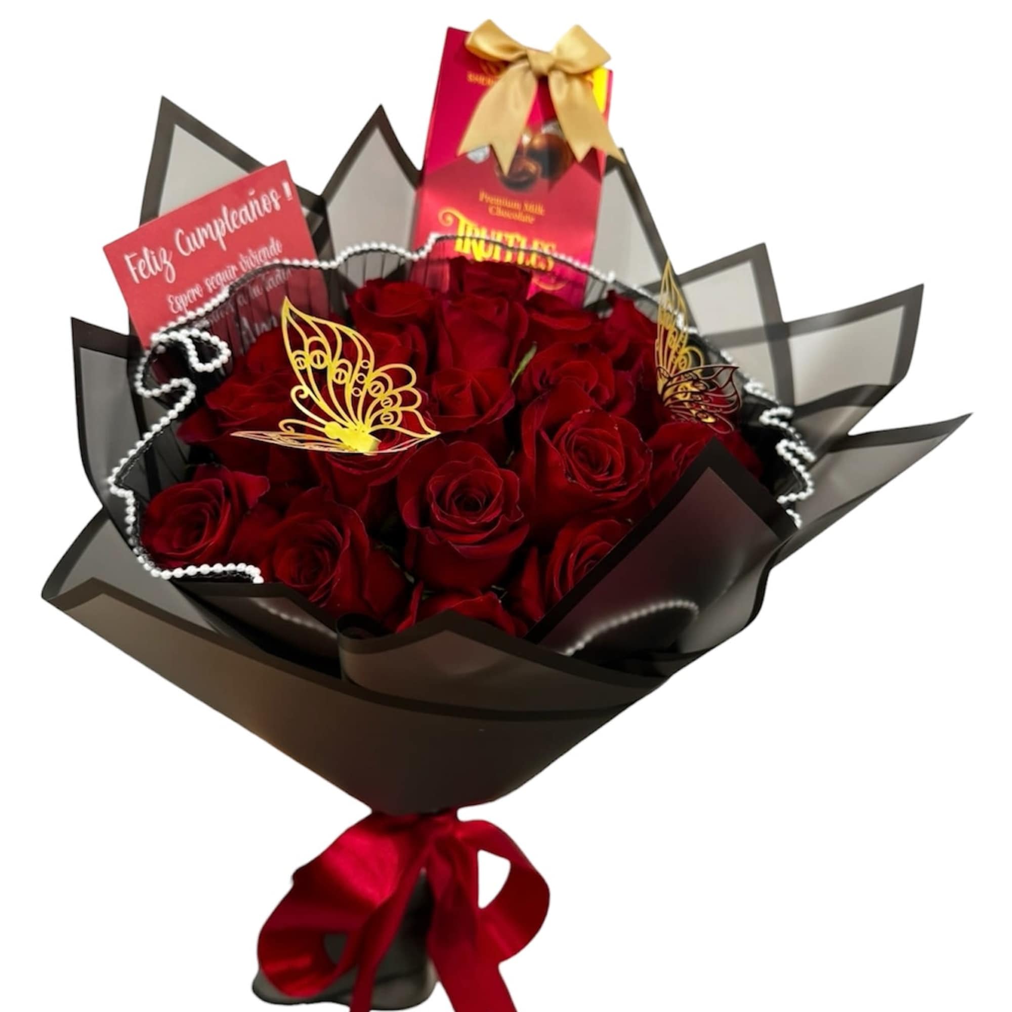 Bouquet of red roses in black wrap with red ribbon, chocolates, and a birthday card.