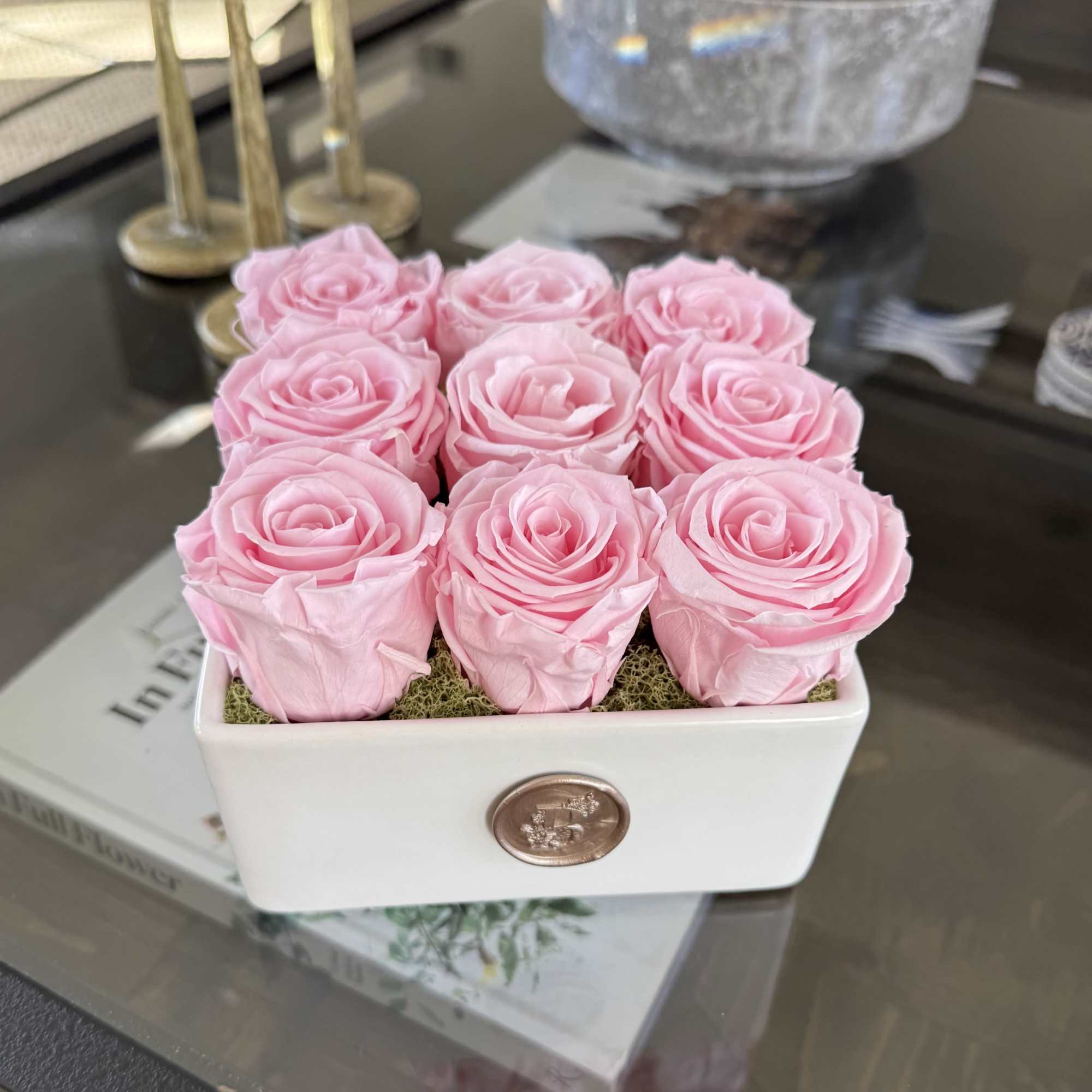 Pink roses arranged in a white rectangular vase