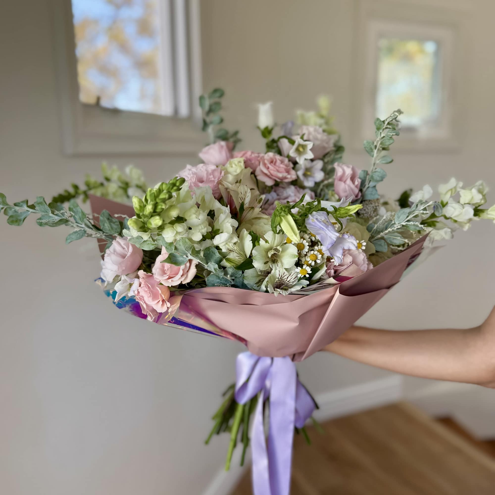 Hand-tied bouquet of pink and white flowers with a lavender ribbon