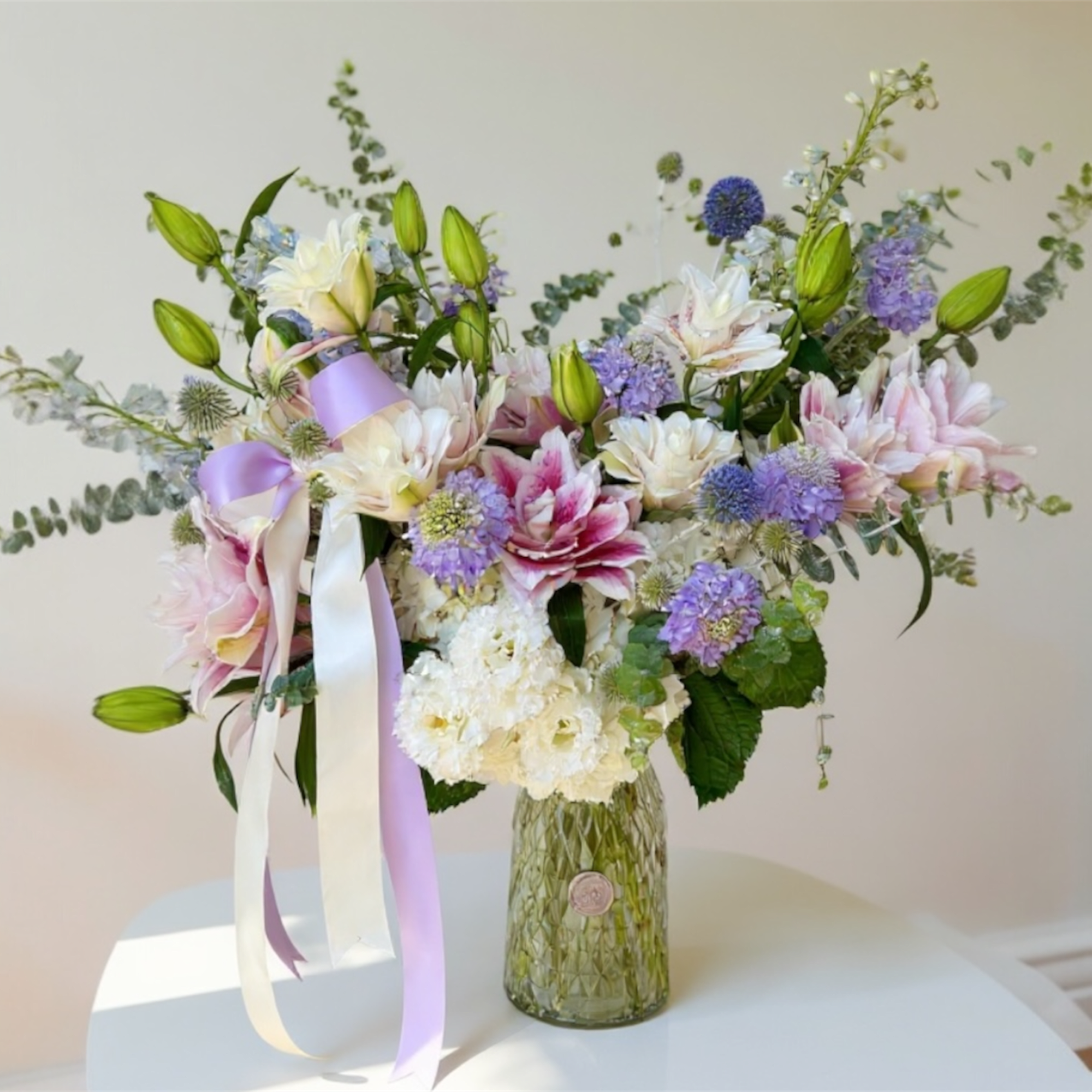 Enchanted Lilies is a tall and graceful arrangement featuring fresh lilies as