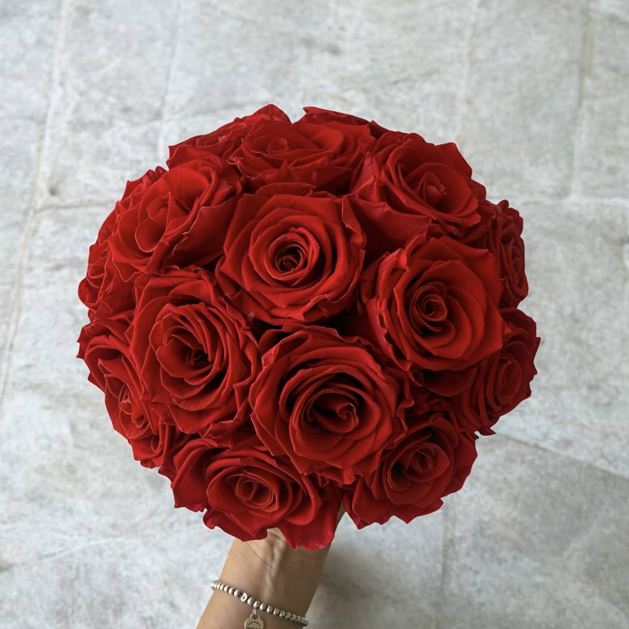 Handheld bouquet of red roses