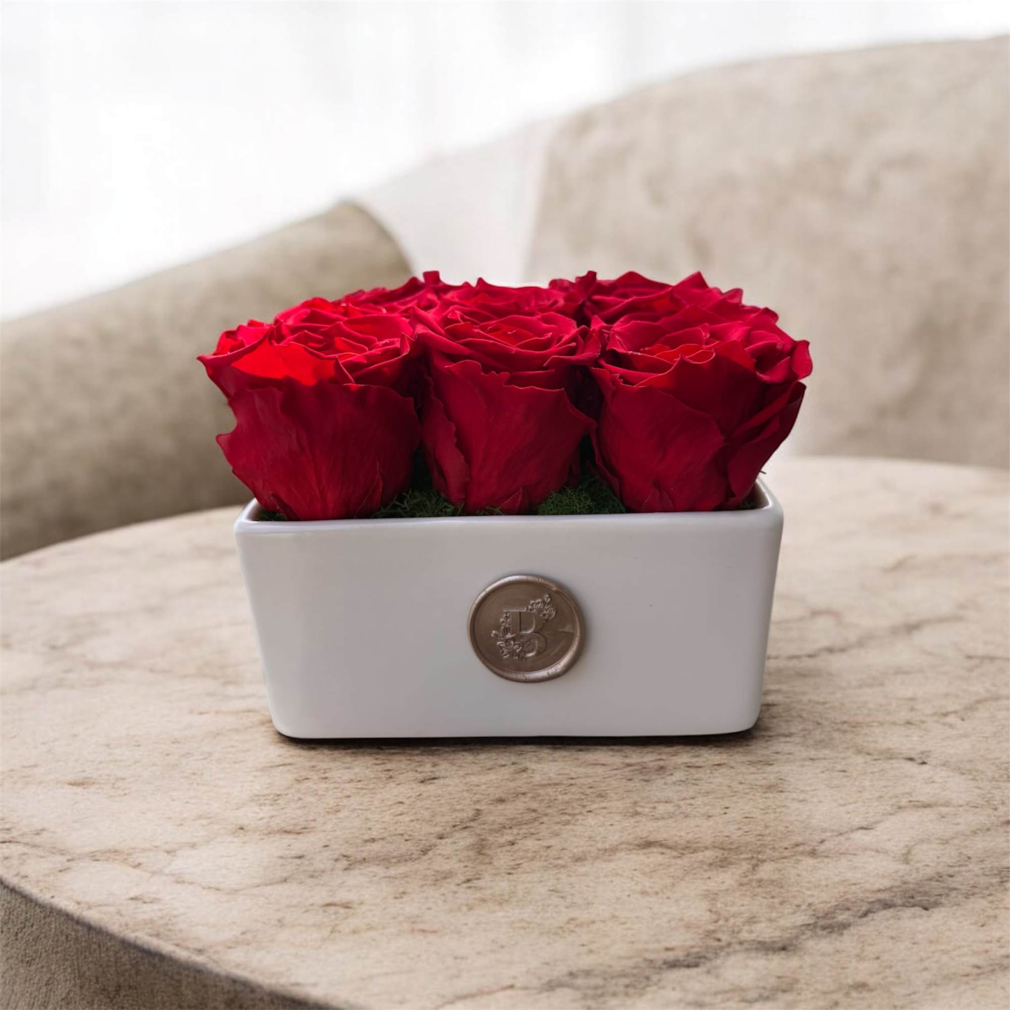 Red roses arranged in a white rectangular vase