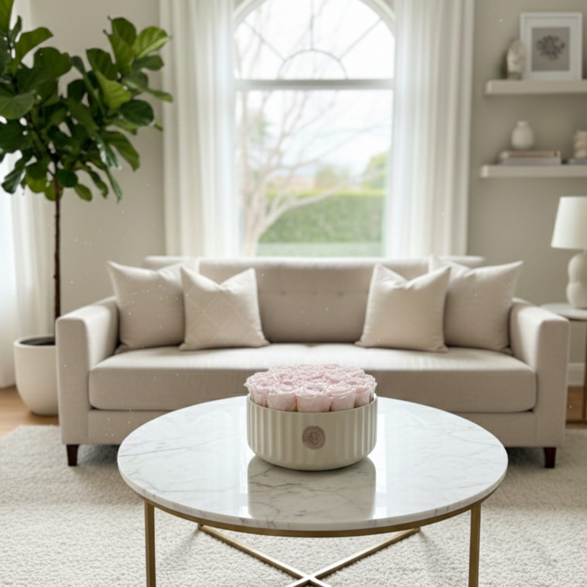 Round box of pale pink roses on a coffee table in a living room