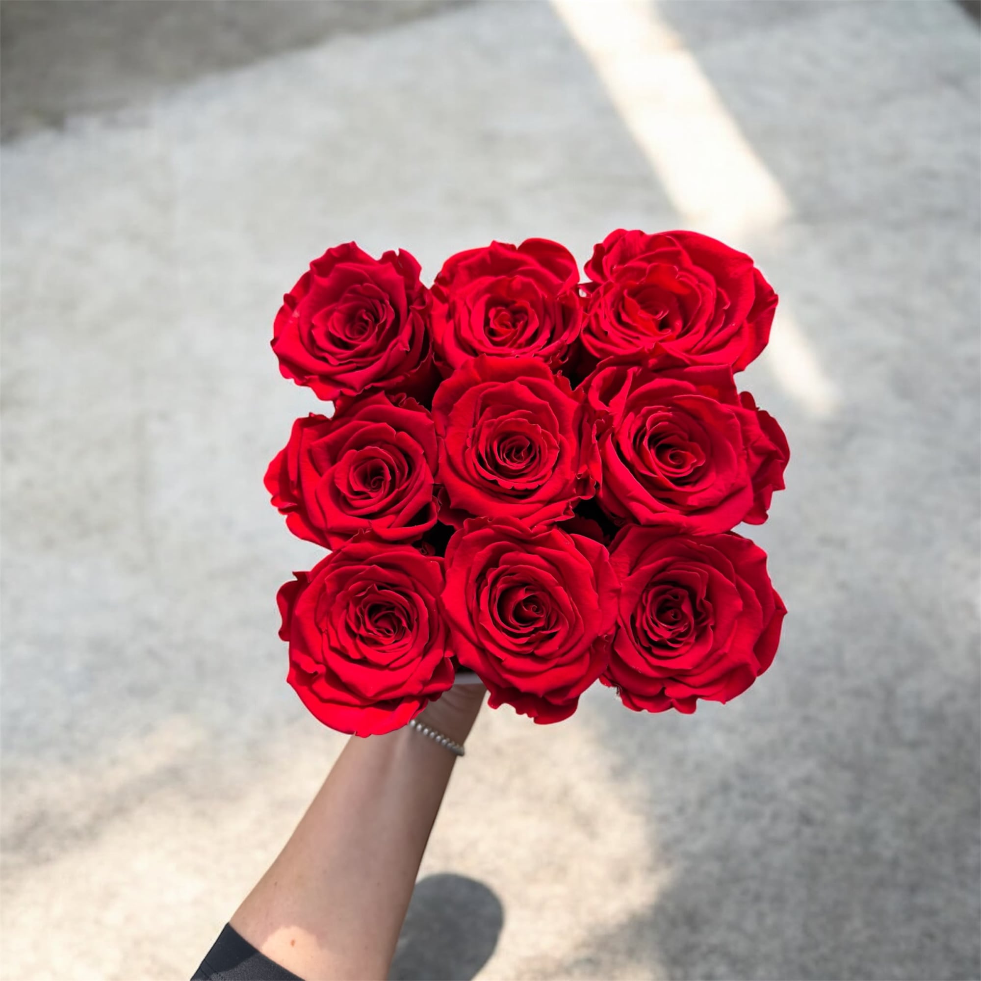 Handheld bouquet of red roses
