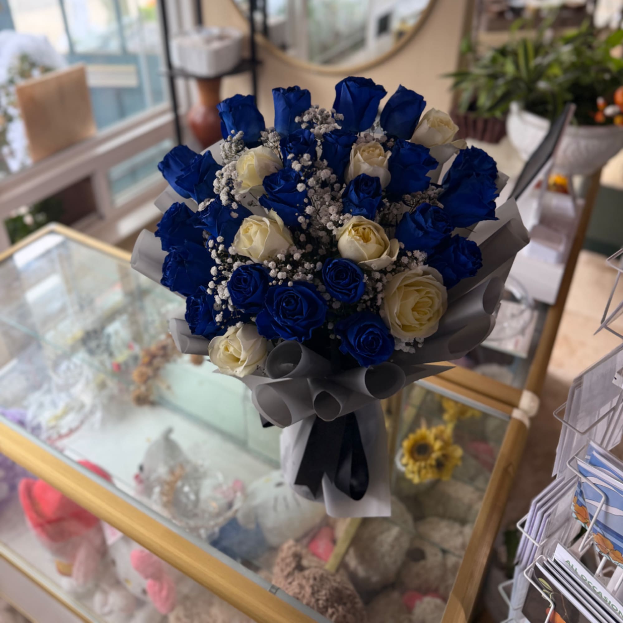 Bouquet of blue and white roses wrapped in gray paper, photo 3 of 3