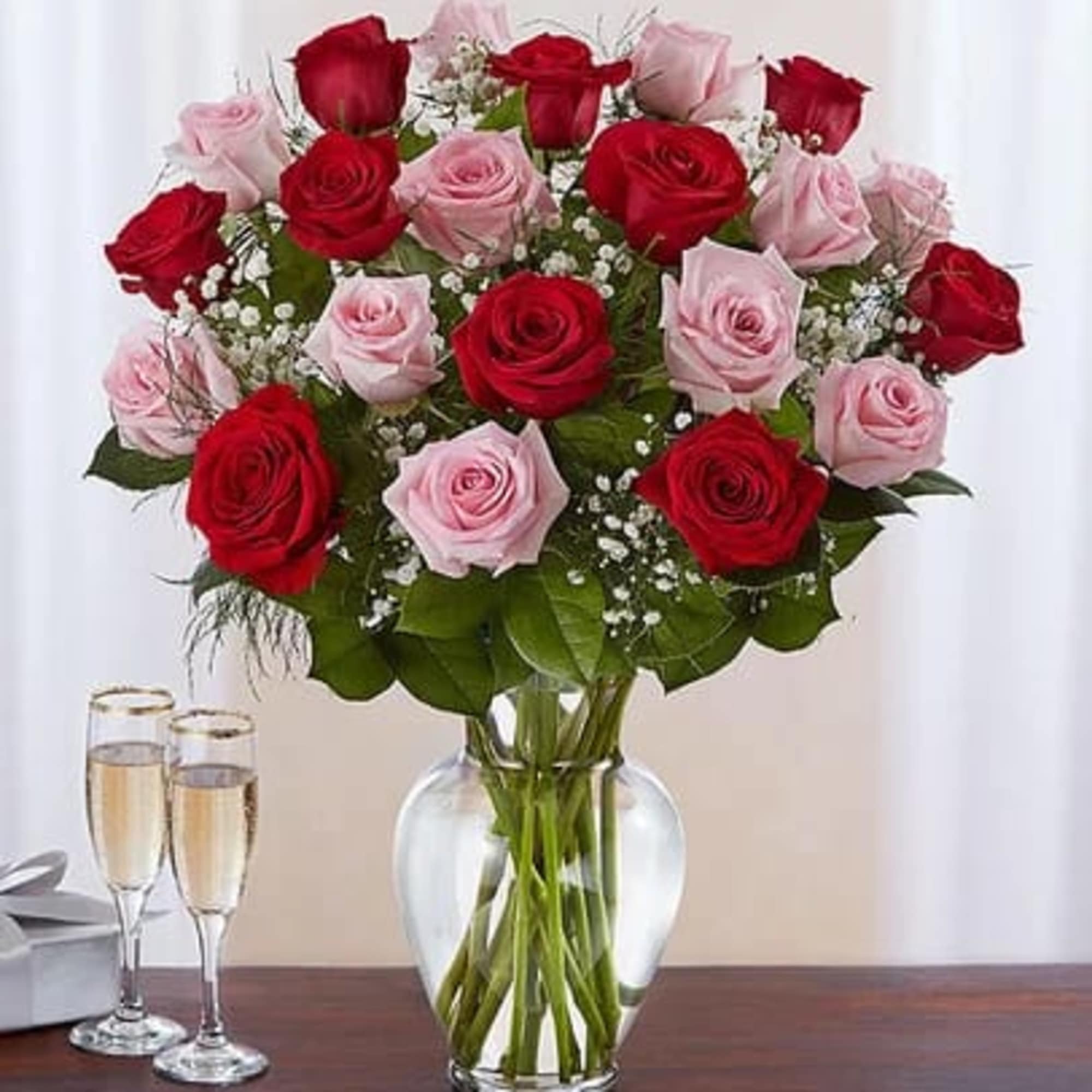 Bouquet of red and pink roses in a clear glass vase