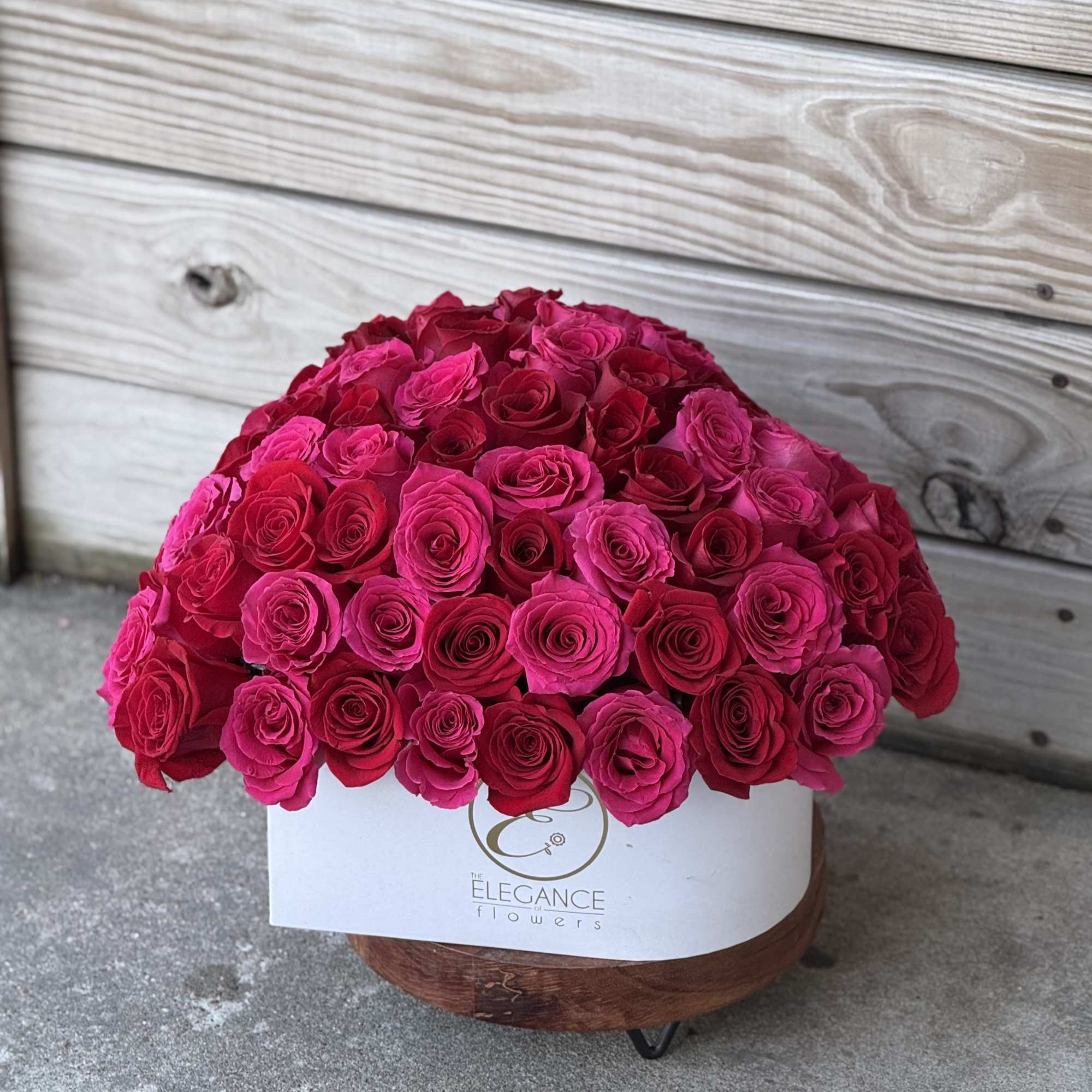 Large dome of hot pink roses in a white box