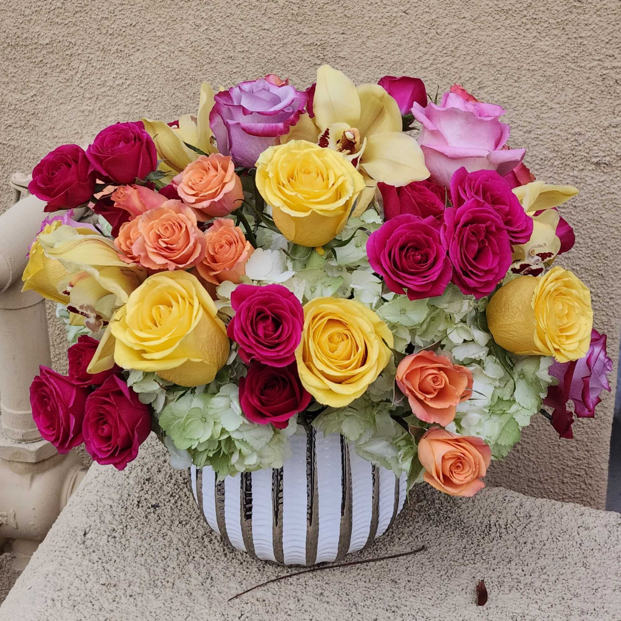 This cylindrical vase of flowers is kind of like a time capsule