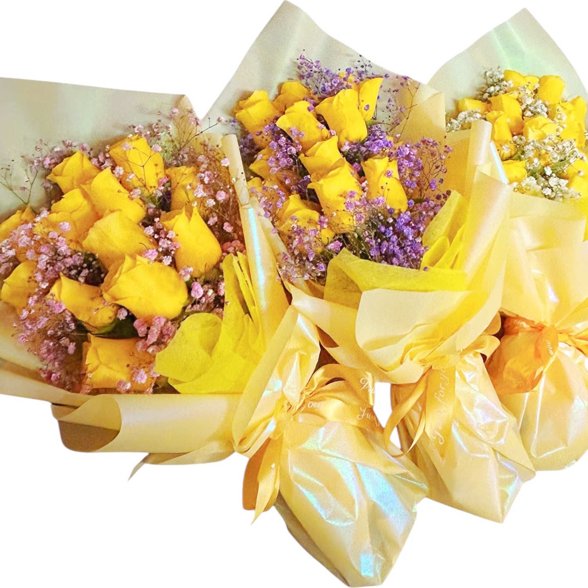 Three bouquets of yellow roses wrapped in pale paper