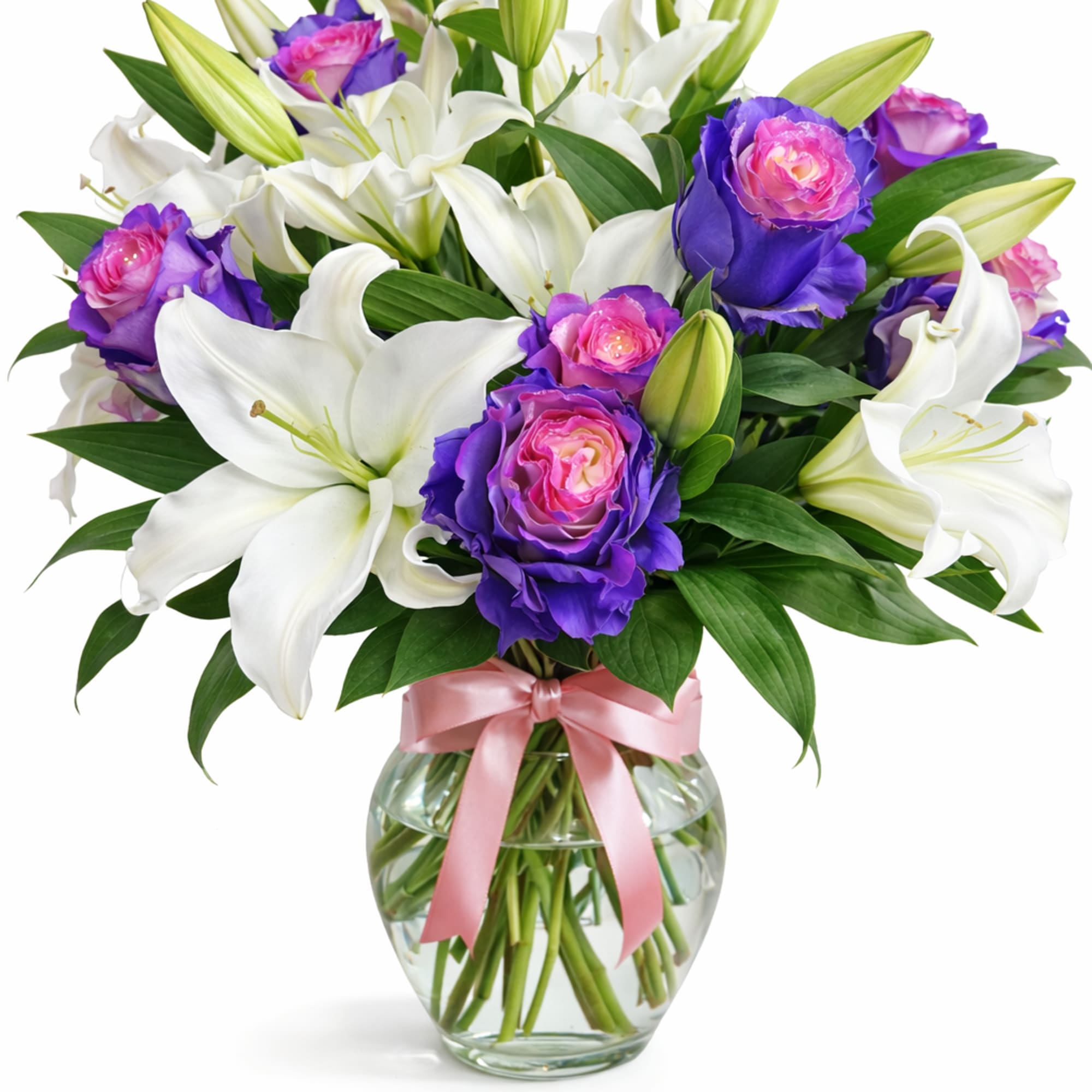 Bouquet of white lilies and purple-pink roses in a glass vase