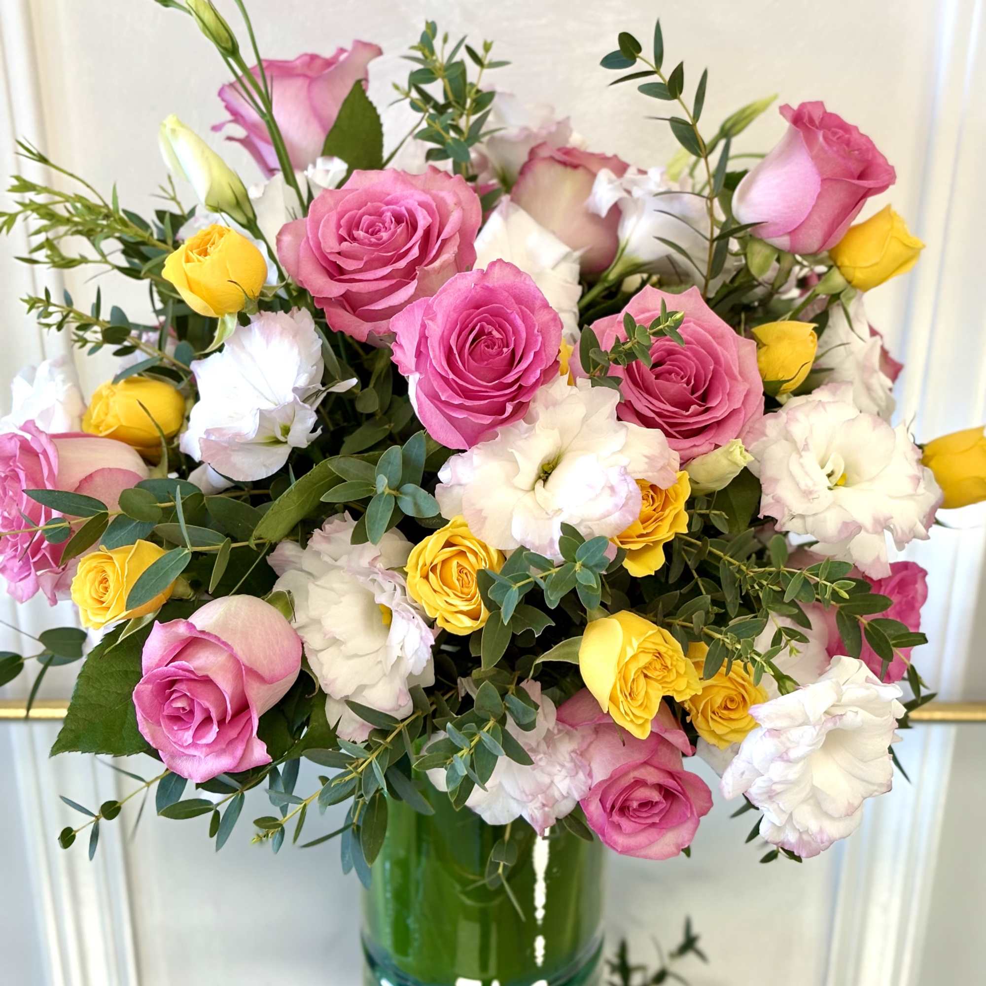 A vibrant bouquet of pink roses, golden yellow spray roses, white lisianthus, photo 2 of 2