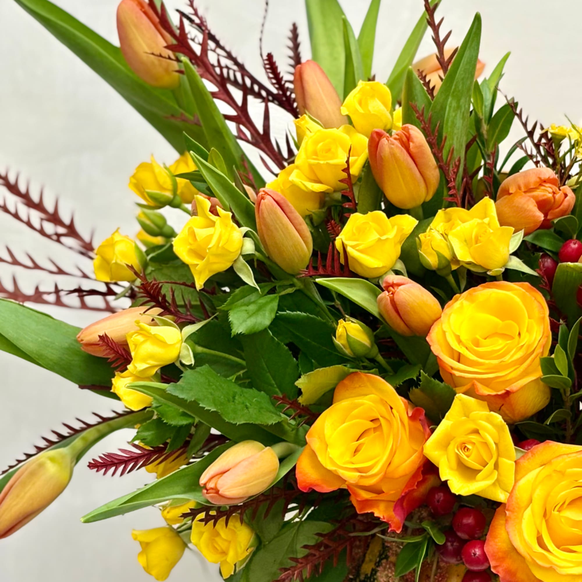 Yellow roses and peach tulips in a mixed bouquet