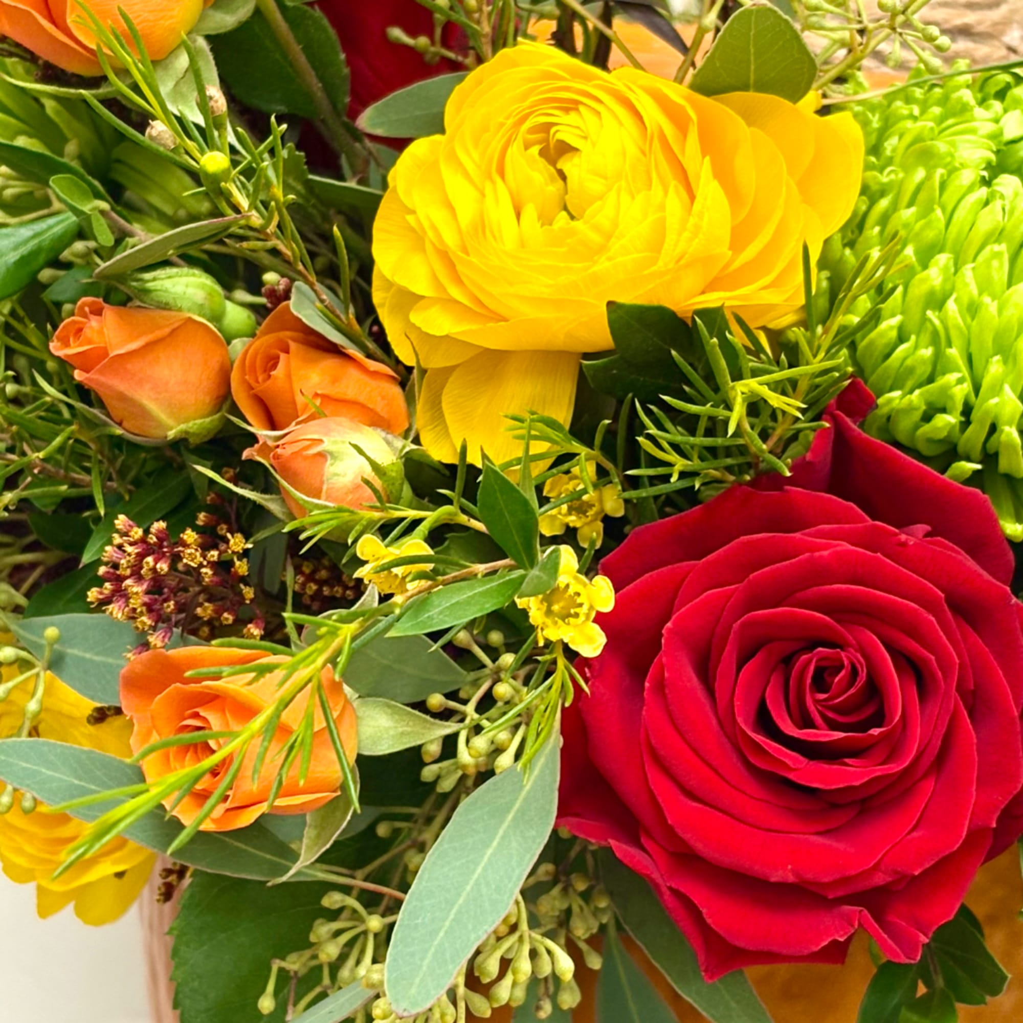 Close-up bouquet with red, yellow, and orange roses